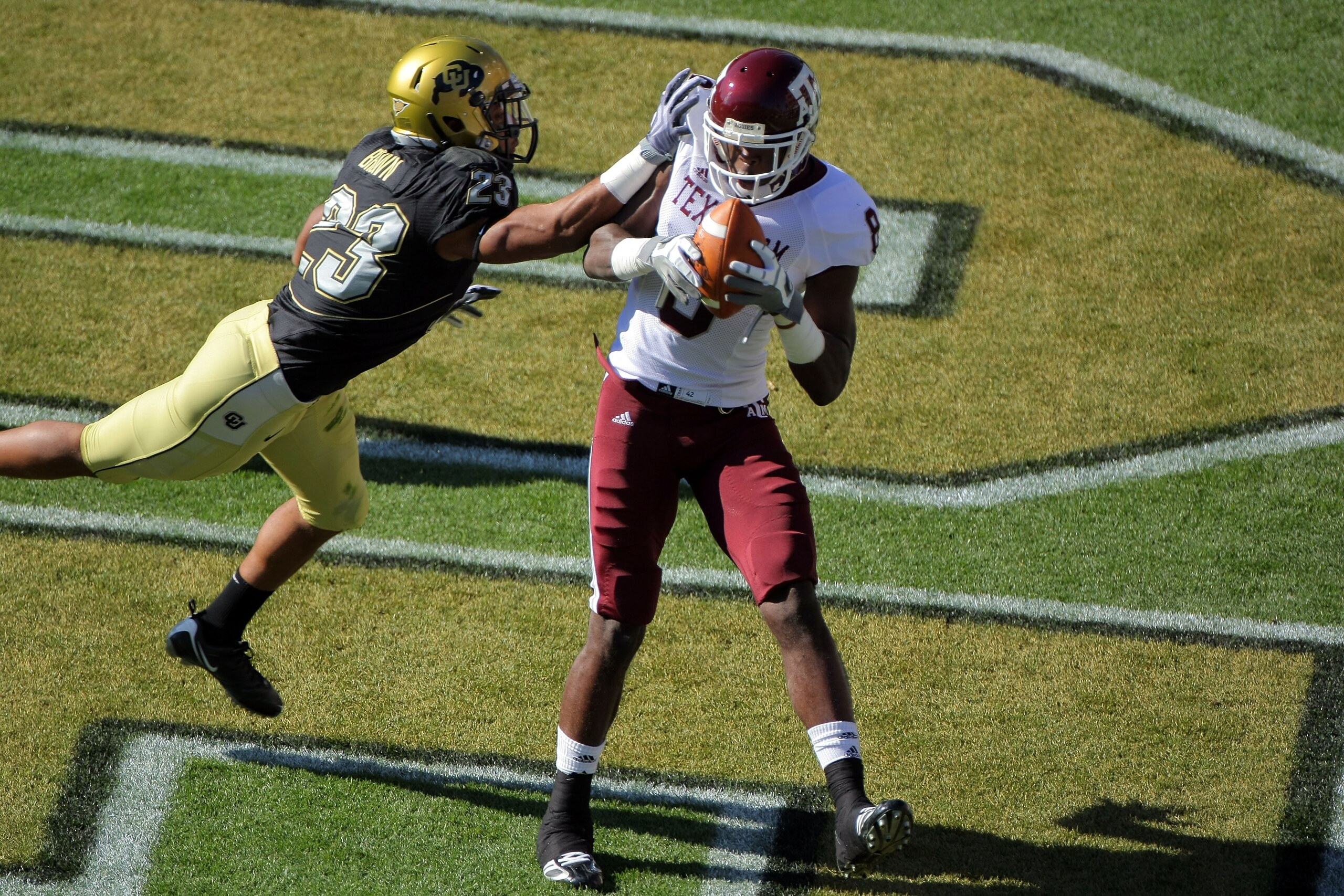 BOULDER, CO - NOVEMBER 07:  Jeff Fuller #8 of the Texas A&M Aggies catches a one yard touchdown pass against the defense of Jalil Brown #23 of the Colorado Buffaloes for the first score of the game in the first quarter during NCAA college football action