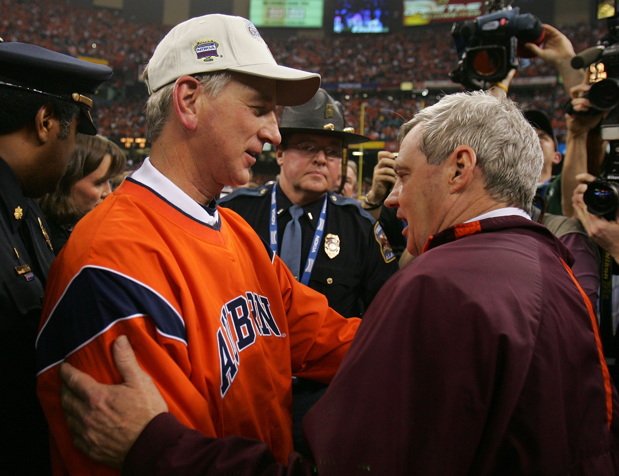 NEW ORLEANS - JANUARY 03:  Head coach Frank Beamer (R) of the Virginia Tech Hokies congratulates head coach Tommy Tuberville of the Auburn Tigers after his team lost to the Tigers 16-13 at the Nokia Sugar Bowl on January 3, 2005 at the Superdome in New Or