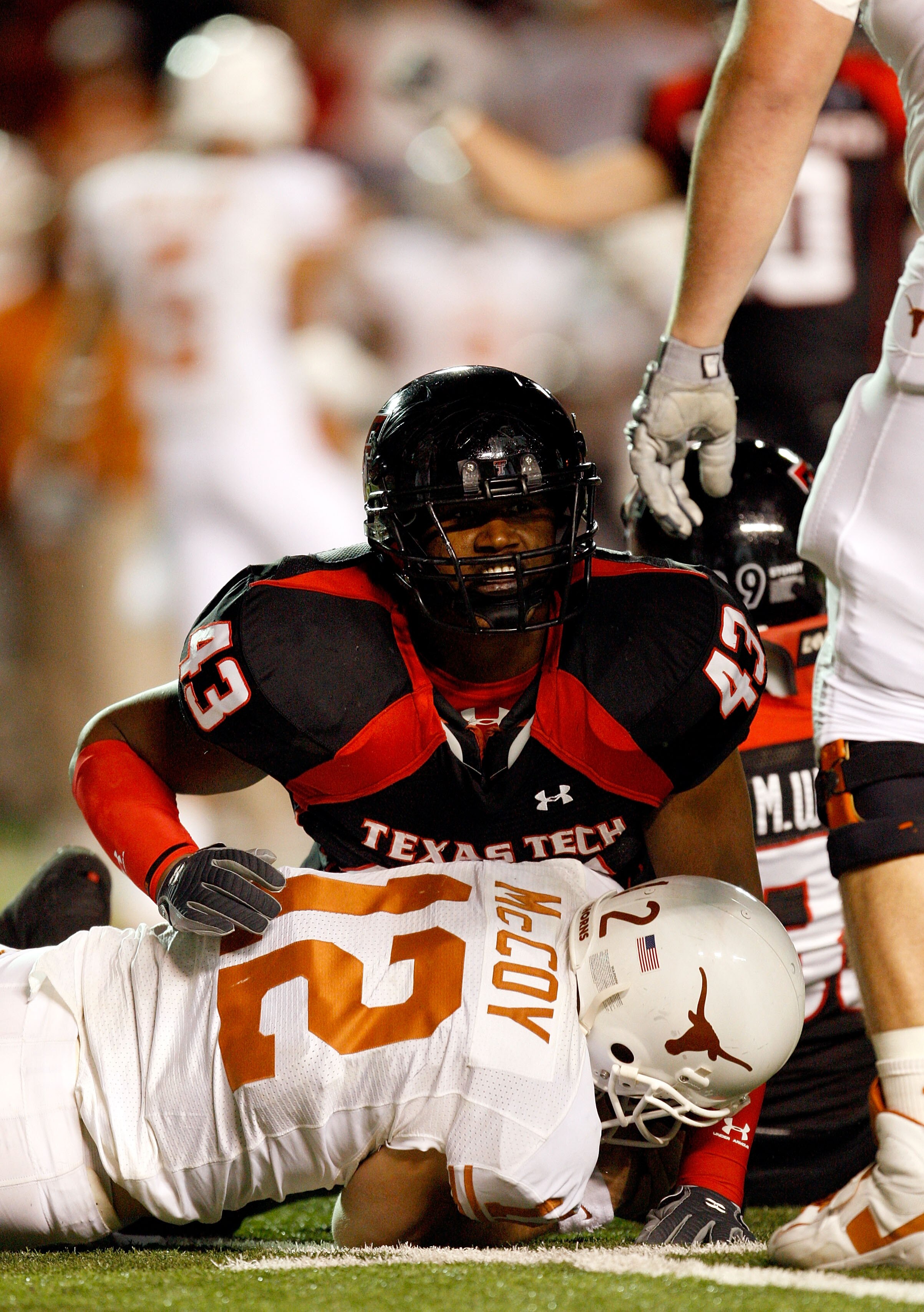 LUBBOCK, TX - NOVEMBER 01:  McKinner Dixon #43 of the Texas Tech Red Raiders tackles sacks quarterback Colt McCoy #12 of the Texas Longhorns during the first half of the game on November 1, 2008 at Jones Stadium in Lubbock, Texas.  (Photo by Jamie Squire/