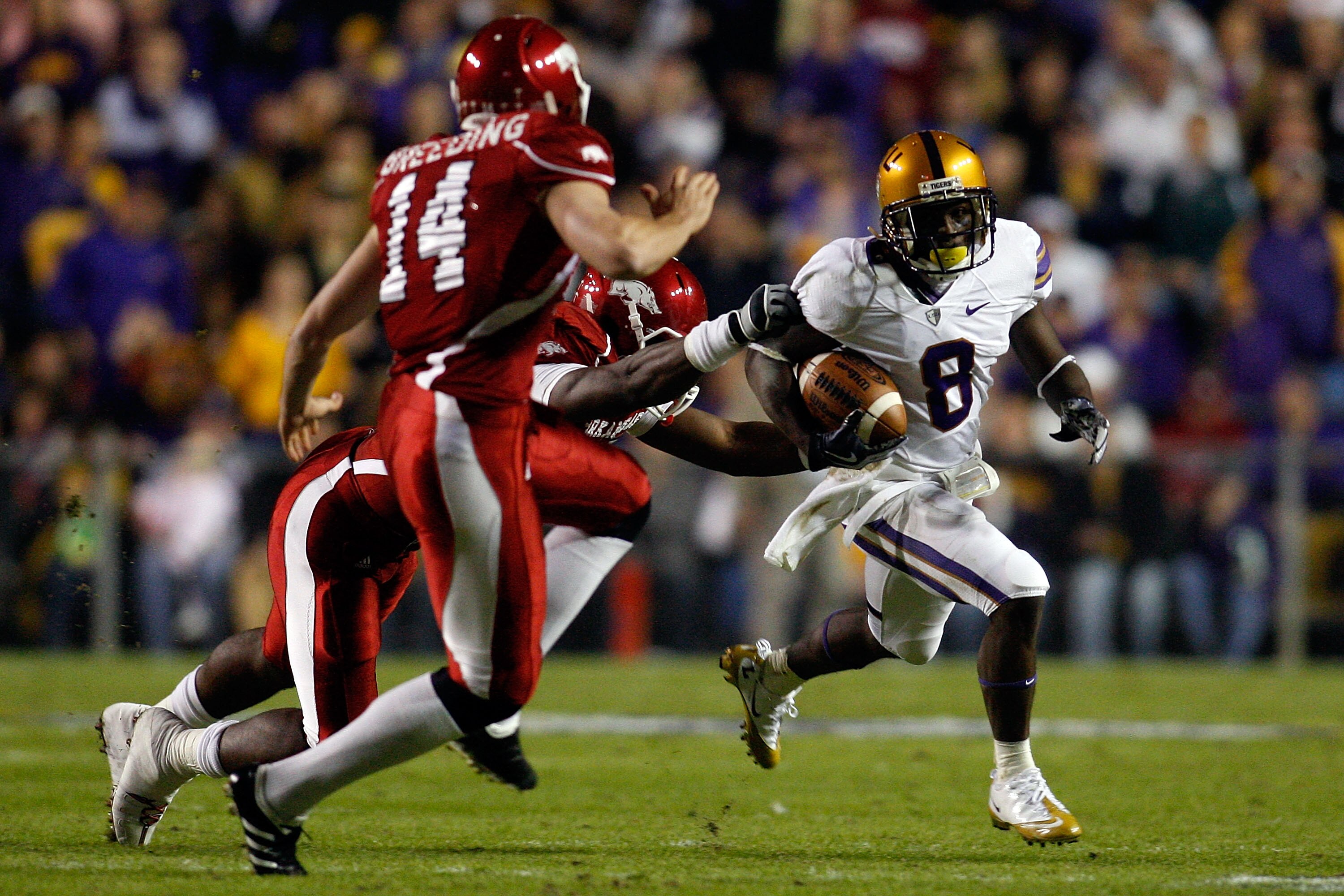 BATON ROUGE, LA - NOVEMBER 28: Trindon Holliday #8 of the Louisiana State University Tigers avoids a tackle by Ronnie Wingo Jr. #20 and Dylan Breeding #14 of the Arkansa Razorbacks at Tiger Stadium on November 28, 2009 in Baton Rouge, Louisiana. (Photo BATON ROUGE, LA - NOVEMBER 28: Trindon Holliday #8 of the Louisiana State University Tigers avoids a tackle by Ronnie Wingo Jr. #20 and Dylan Breeding #14 of the Arkansa Razorbacks at Tiger Stadium on November 28, 2009 in Baton Rouge, Louisiana. (Photo