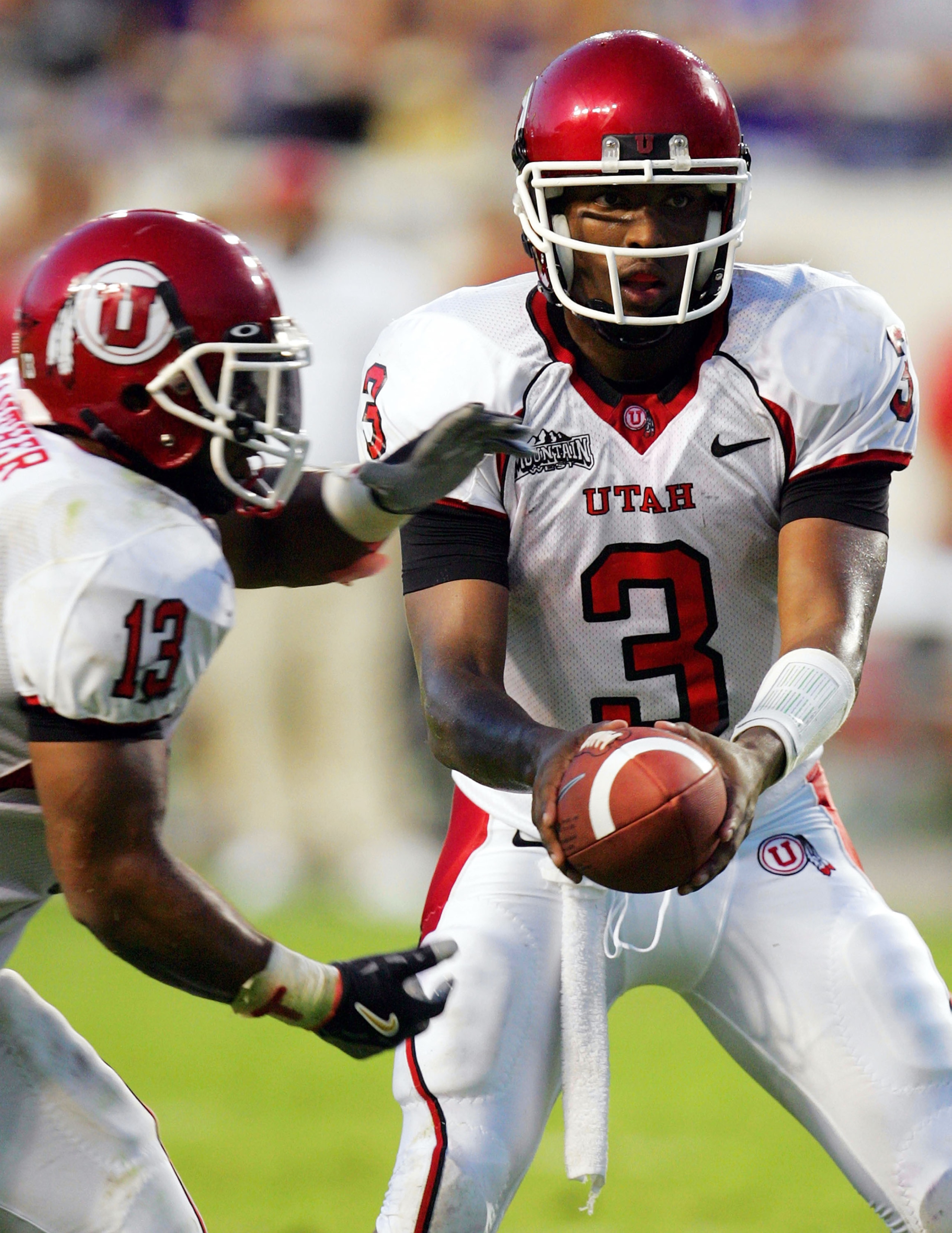 FORT WORTH, TX - SEPTEMBER 15:  Quarterback Brian Johnson #3 of the Utah Utes hands the ball to Quinton Ganther #13 during play against the Texas Christian University Horned Frogs on September 15, 2005 at Amon Carter Stadium in Fort Worth, Texas.  (Photo