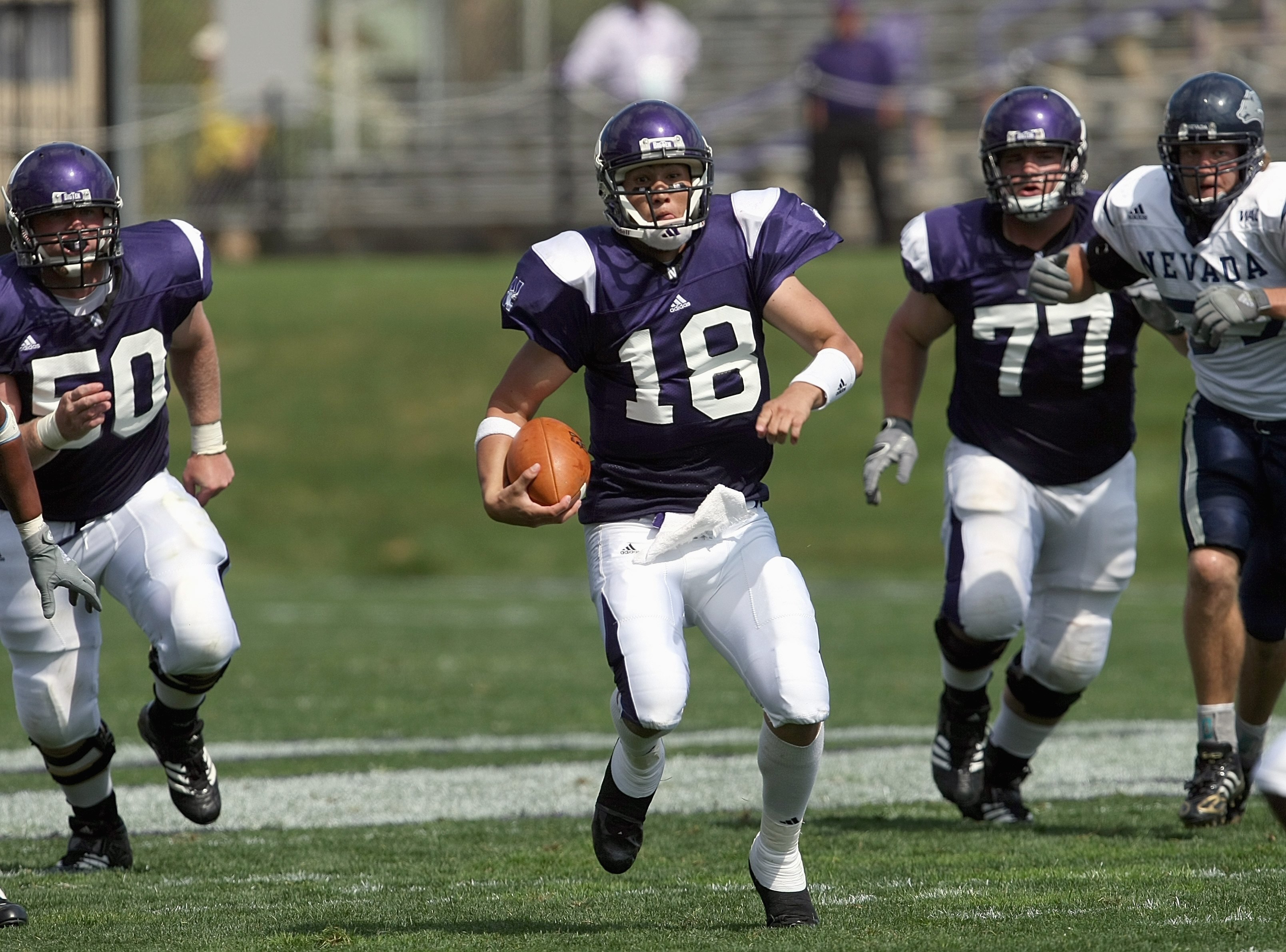 EVANSTON, IL - SEPTEMBER 8: Quarterback C.J. Bacher #18 of the Northwestern Wildcats runs the ball during the game against the Nevada Wolf Pack on September 8, 2007 at Ryan Field at Northwestern University in Evanston, Illinois. (Photo by Jonathan Daniel/
