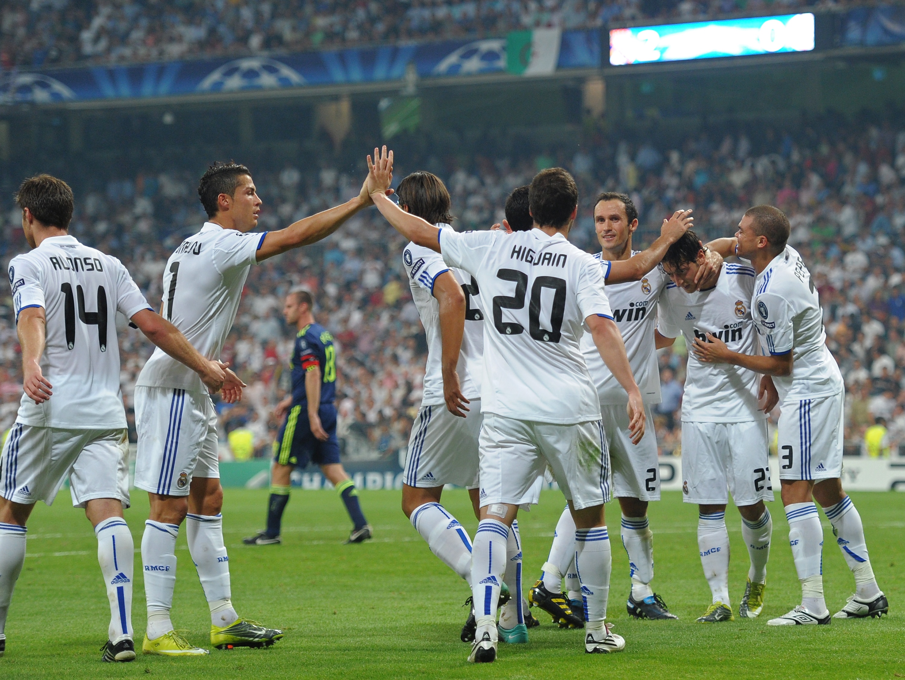 MADRID, SPAIN - SEPTEMBER 15:  Gonzalo Higuain (C) of Real Madrid celebrates scoring his sides second goal with Cristiano Ronaldo (2nd L) and Mesut Ozil (2nd R) who gave the assist, during the UEFA Champions League group G match between Real Madrid and Aj