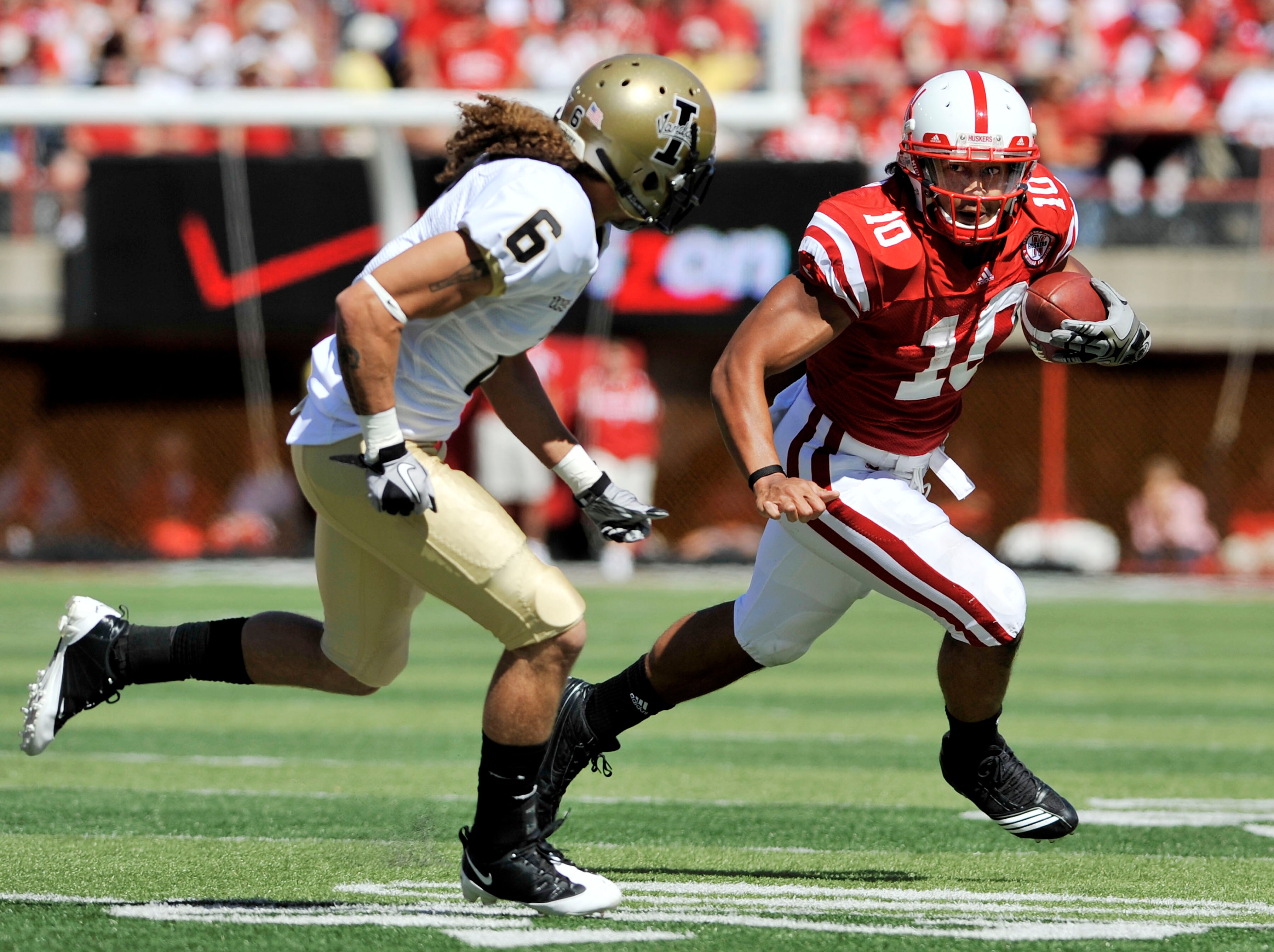 LINCOLN, NEBRASKA - SEPTEMBER 11: Nebraska Cornhuskers running back Roy Helu Jr. #10 runs past Idaho Vandals cornerback Aaron Grymes #6 during first half action of their game at Memorial Stadium on September 4, 2010 in Lincoln, Nebraska. Nebraska defeated