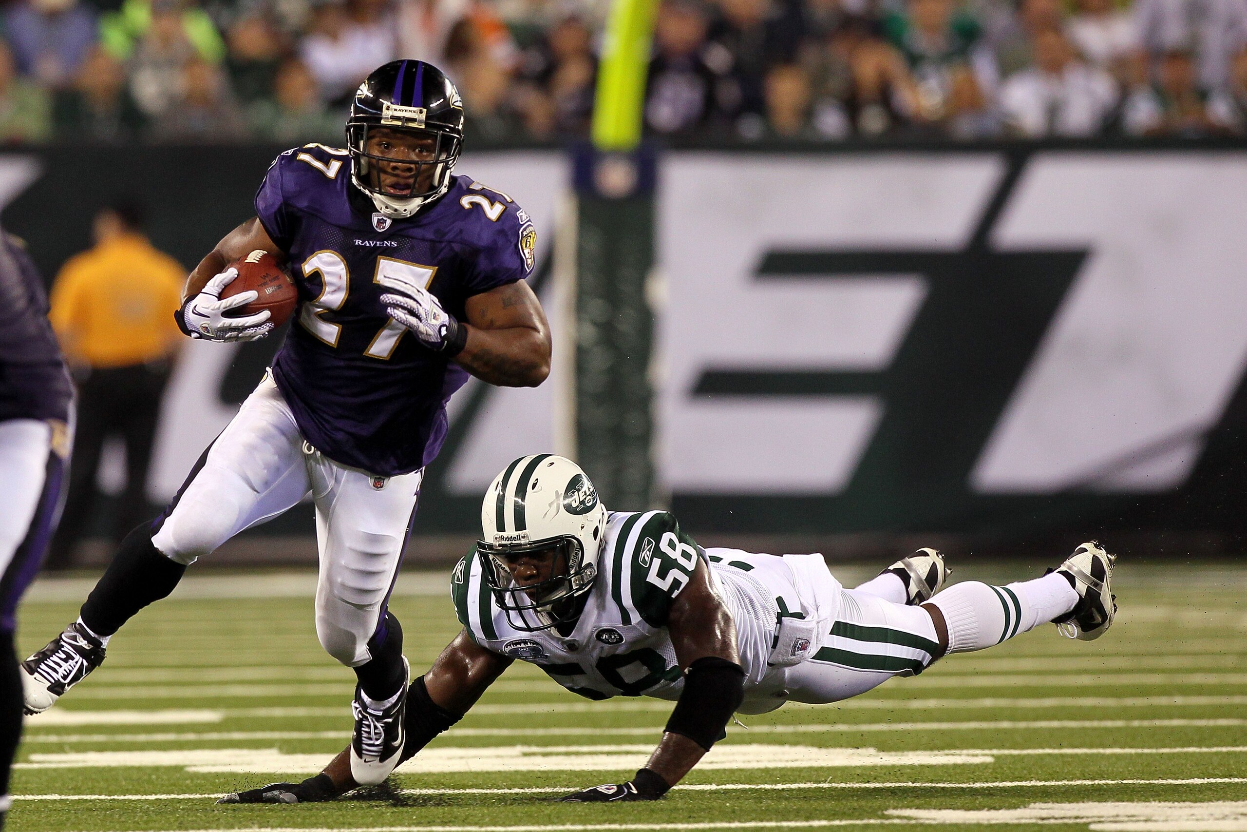 EAST RUTHERFORD, NJ - SEPTEMBER 13: Ray Rice #27 of the Baltimore Ravens runs against Bryan Thomas #58 of the New York Jets during their home opener at the New Meadowlands Stadium on September 13, 2010 in East Rutherford, New Jersey. (Photo by Jim McIsa EAST RUTHERFORD, NJ - SEPTEMBER 13: Ray Rice #27 of the Baltimore Ravens runs against Bryan Thomas #58 of the New York Jets during their home opener at the New Meadowlands Stadium on September 13, 2010 in East Rutherford, New Jersey. (Photo by Jim McIsa