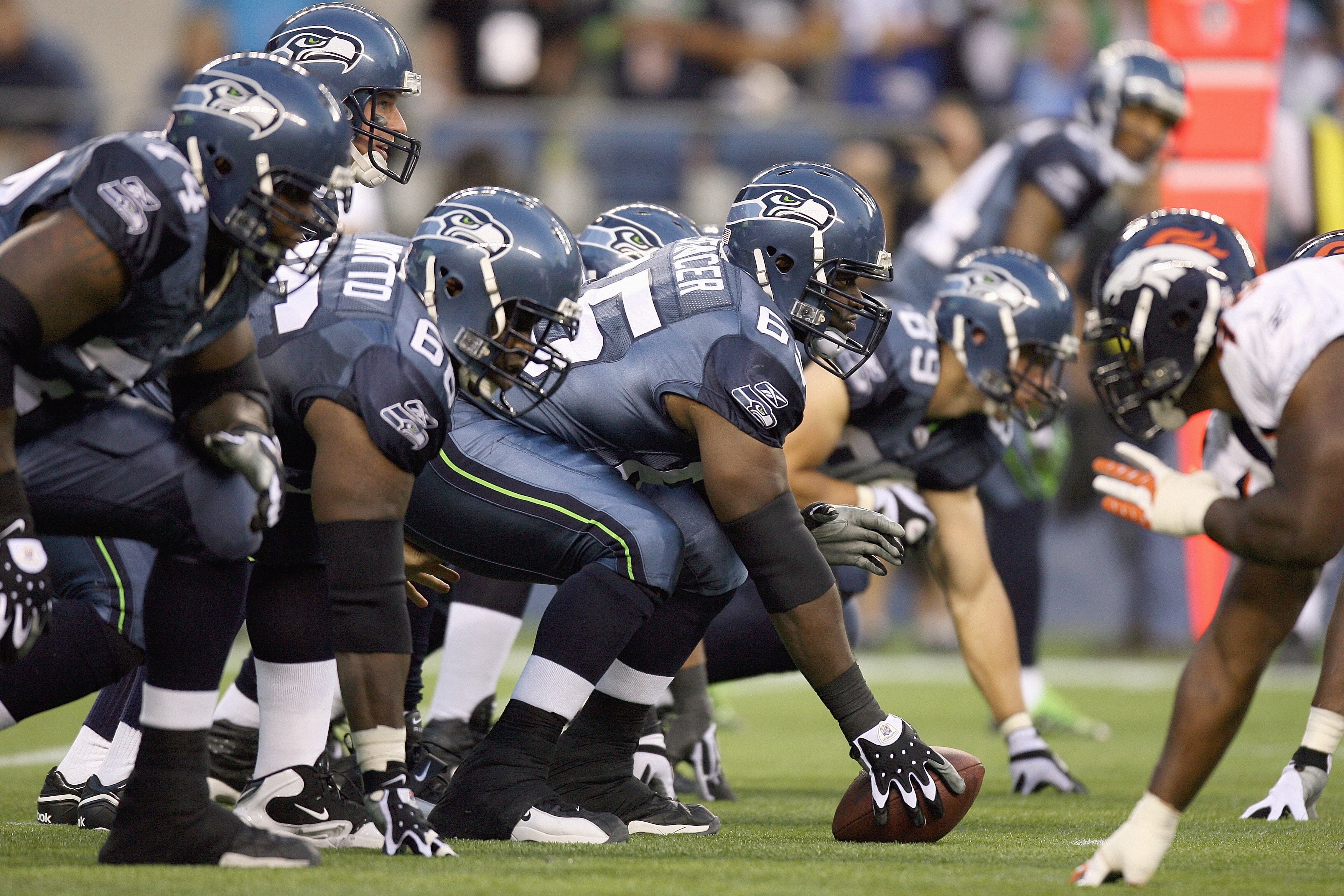 SEATTLE - AUGUST 22:  Center Chris Spencer #65 of the Seattle Seahawks gets ready to hike the ball during the game against the Denver Broncos on August 22, 2009 at Qwest Field in Seattle, Washington. (Photo by Otto Greule Jr/Getty Images)