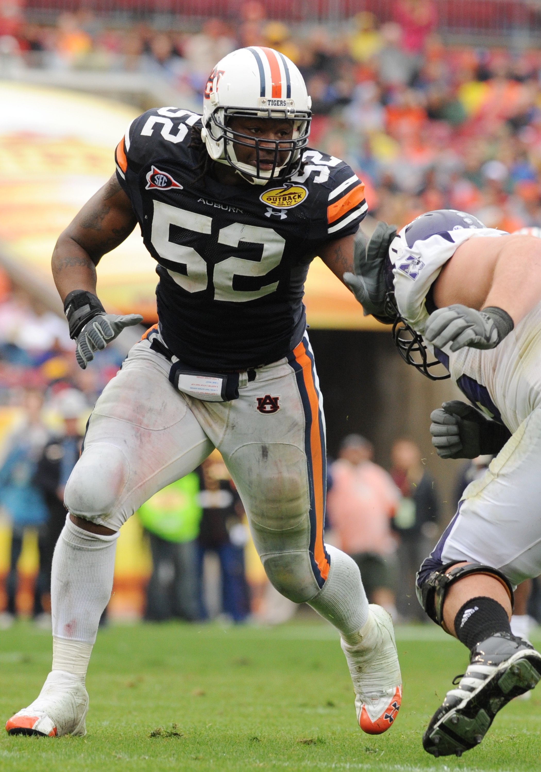 TAMPA, FL - JANUARY 1: Defensive end Antonio Coleman #52 of the Auburn Tigers sets on defense against the Northwestern Wildcats in the Outback Bowl January 1, 2010 at Raymond James Stadium in Tampa, Florida. (Photo by Al Messerschmidt/Getty Images) TAMPA, FL - JANUARY 1: Defensive end Antonio Coleman #52 of the Auburn Tigers sets on defense against the Northwestern Wildcats in the Outback Bowl January 1, 2010 at Raymond James Stadium in Tampa, Florida. (Photo by Al Messerschmidt/Getty Images)