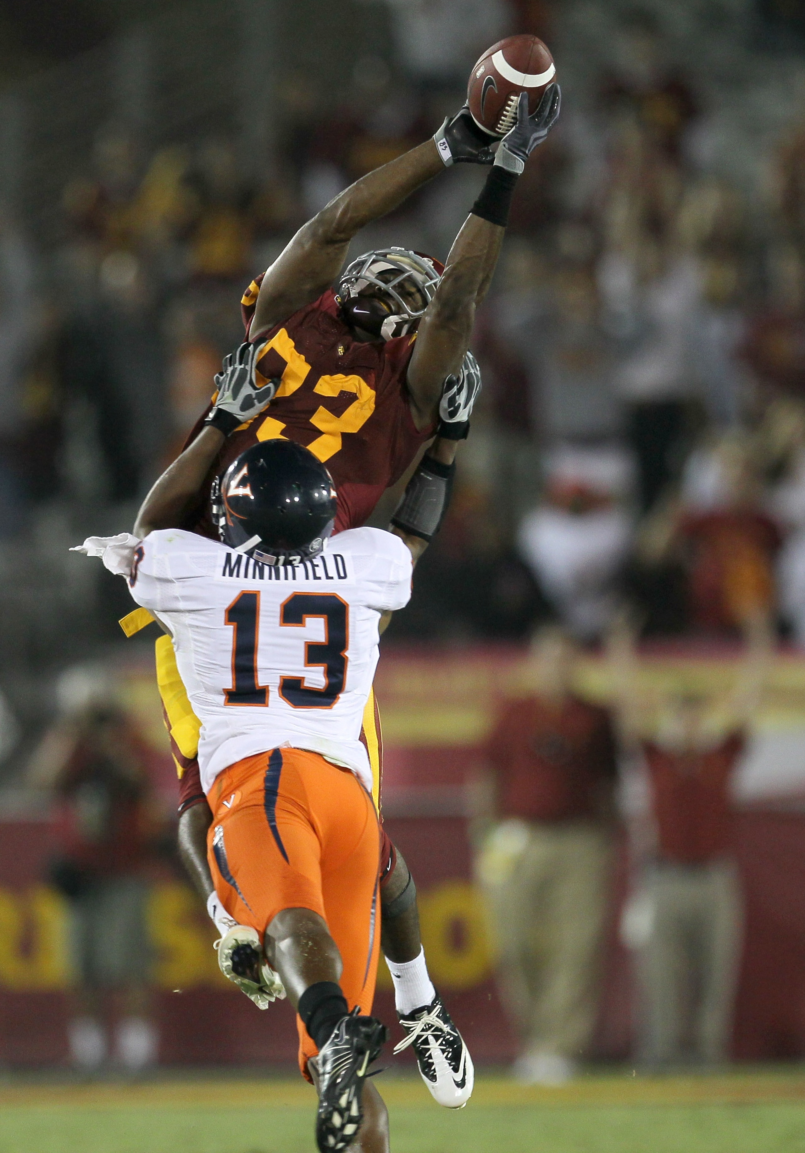 LOS ANGELES, CA - SEPTEMBER 11:  Wide receiver Ronald Johnson #83 of the USC Trojans reaches for the ball over cornerback Chase Minnifield #13 of the Virginia Cavaliers at Los Angeles Memorial Coliseum on September 11, 2010 in Los Angeles, California. USC