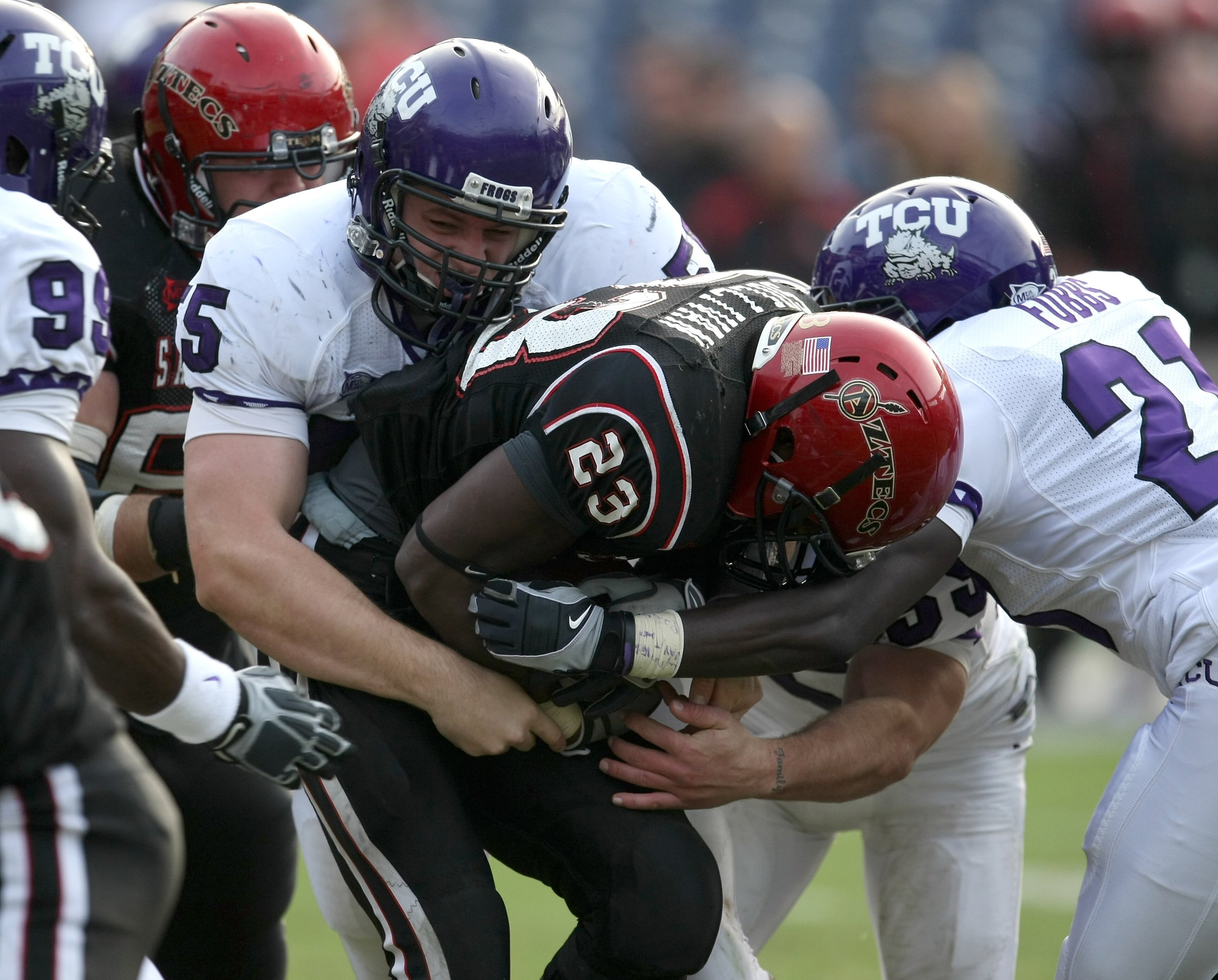 SAN DIEGO - NOVEMBER 7: Defensive lineman D.J. Yendrey #55 of the Texas Christian University Horned Frogs tackles runing back Brandon Sullivan #23 of the San Diego State Aztecs on November 7, 2009 at Qualcomm Stadium in San Diego, California. TCU won SAN DIEGO - NOVEMBER 7: Defensive lineman D.J. Yendrey #55 of the Texas Christian University Horned Frogs tackles runing back Brandon Sullivan #23 of the San Diego State Aztecs on November 7, 2009 at Qualcomm Stadium in San Diego, California. TCU won