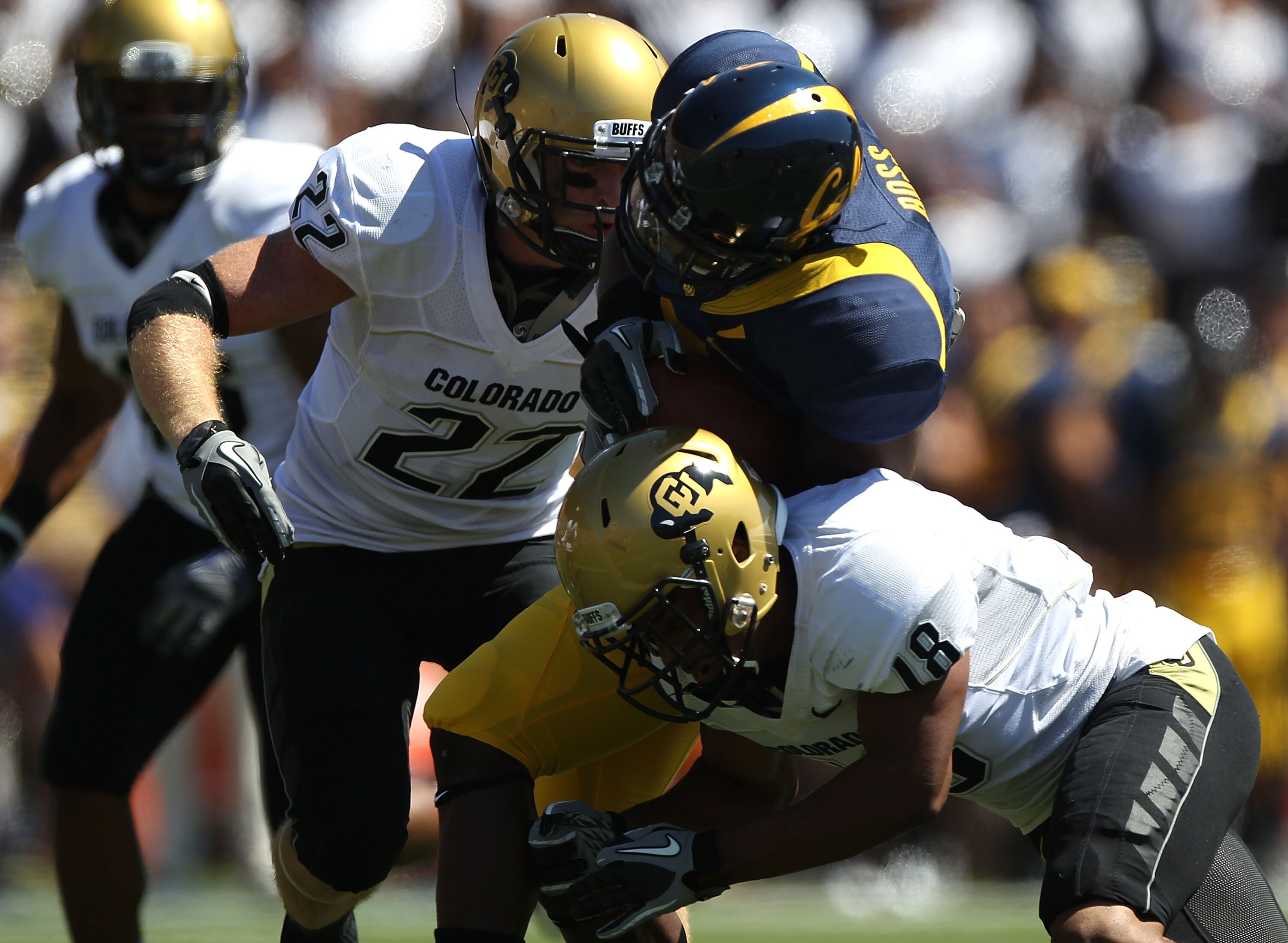 BERKELEY, CA - SEPTEMBER 11:  Jeremy Ross #3 of the California Golden Bears runs against Jonathan Hawkins #18 and Arthur Jaffee #22 of the Colorado Buffaloes at California Memorial Stadium on September 11, 2010 in Berkeley, California.  (Photo by Jed Jaco