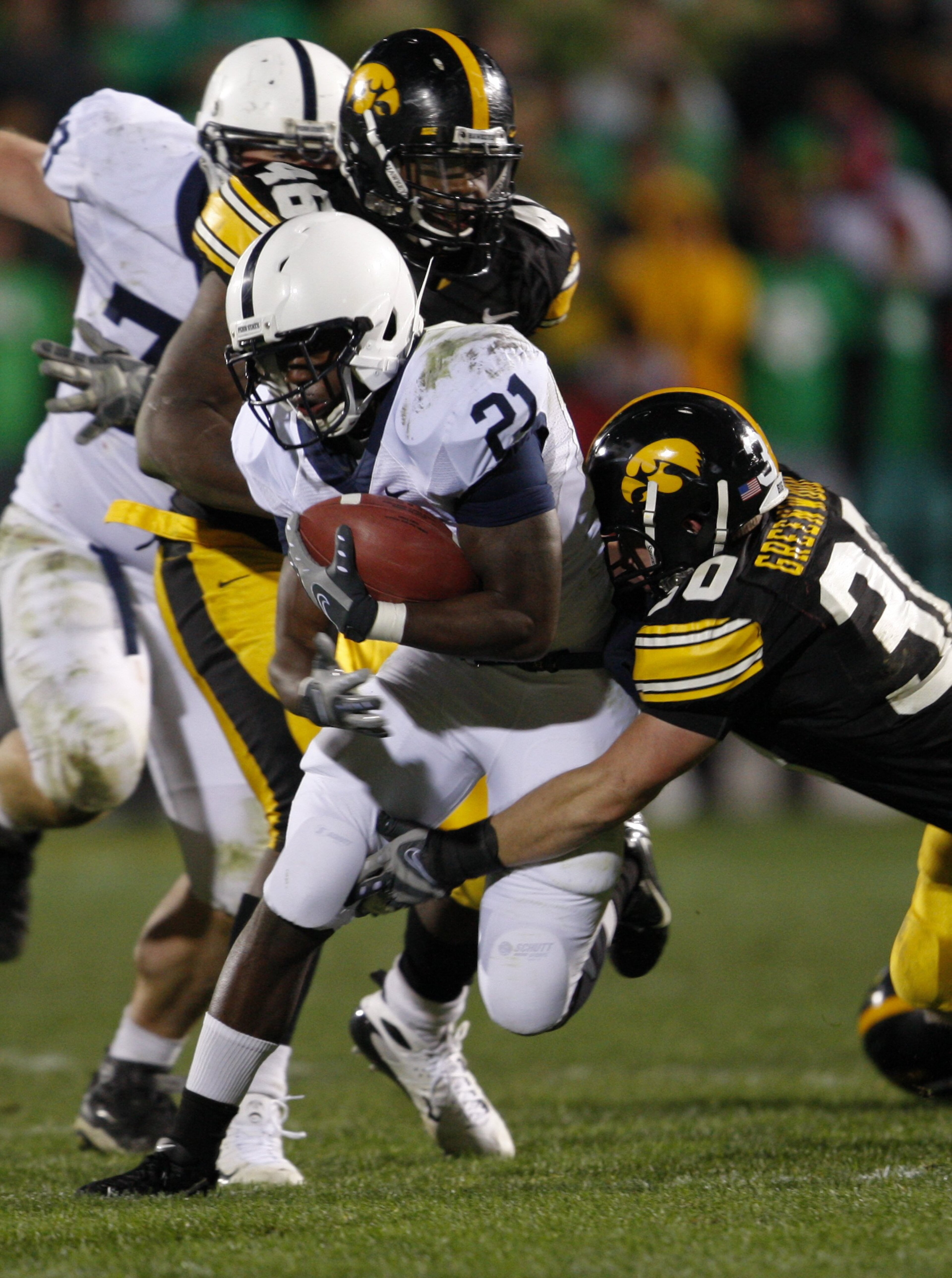 IOWA CITY, IOWA - NOVEMBER 8:  Runningback Stephon Green #21 of the Penn State Nittany Lions is tackled by Christian Ballard #46 and Brett Greenwood #30 of the Iowa Hawkeyes in the third quarter of play at Kinnick Stadium on November 8, 2008 in Iowa City,