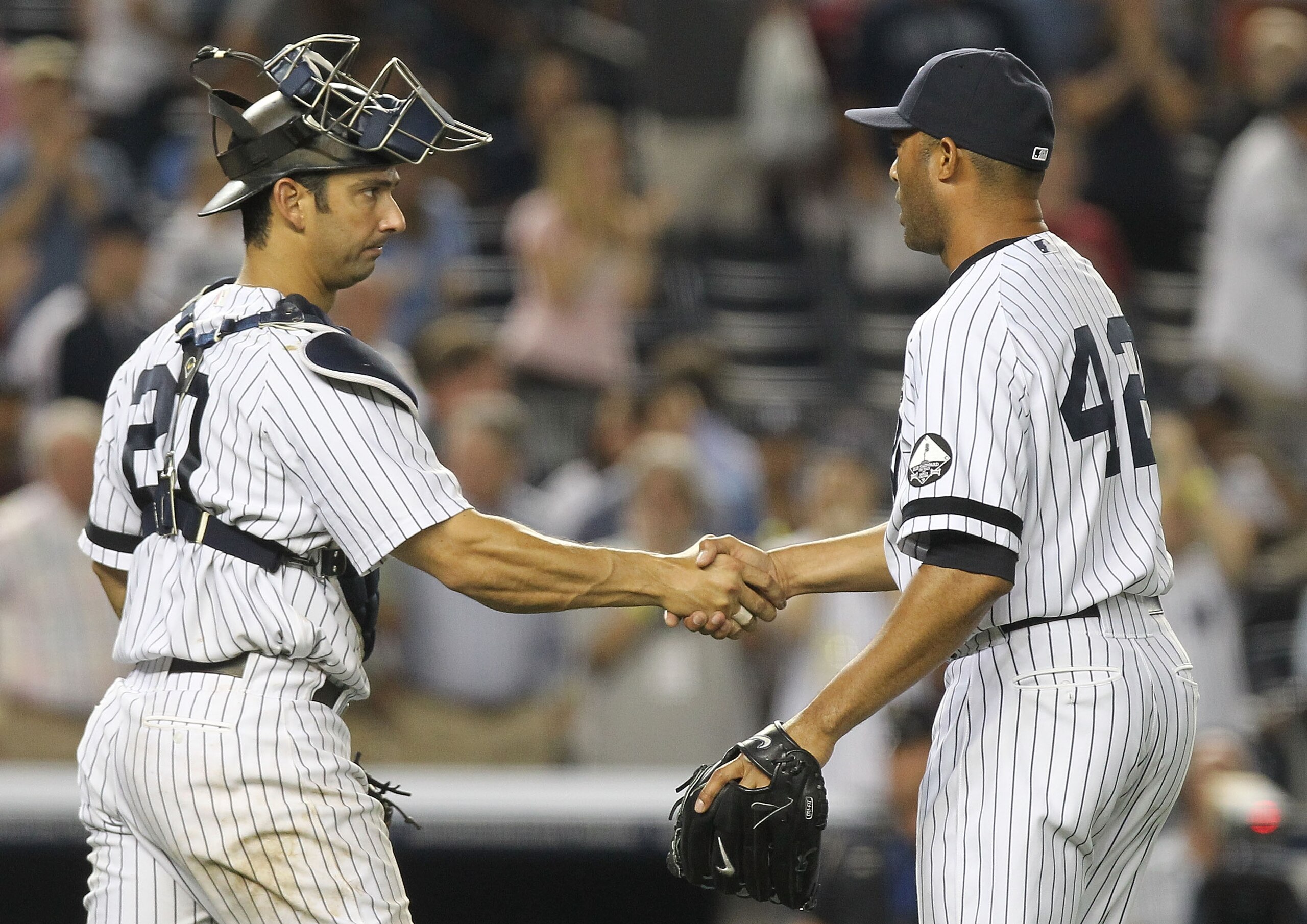 NEW YORK - AUGUST 18:  Mariano Rivera #42 of the New York Yankees celebrates the win with catcher Jorge Posada #20 against the Detroit Tigers at Yankee Stadium on August 18, 2010 in the Bronx borough of New York City.  (Photo by Nick Laham/Getty Images)