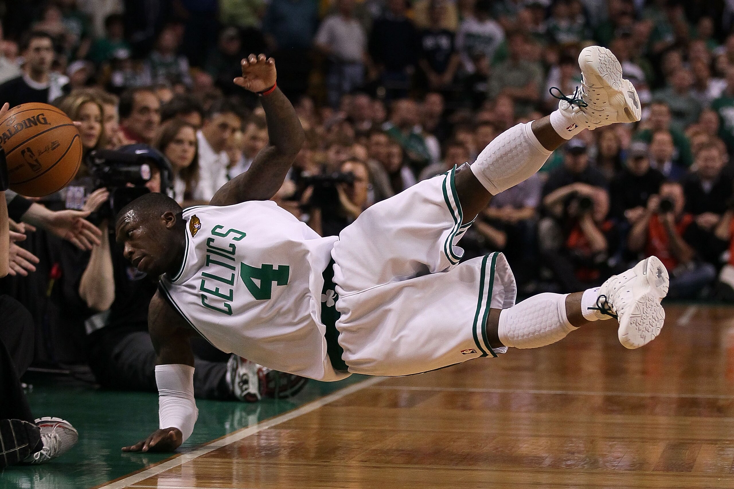 BOSTON - JUNE 10:  Nate Robinson #4 of the Boston Celltics falls out of bounds going after a loose ball in the fourth quarter against the Los Angeles Lakers during Game Four of the 2010 NBA Finals on June 10, 2010 at TD Garden in Boston, Massachusetts. NO