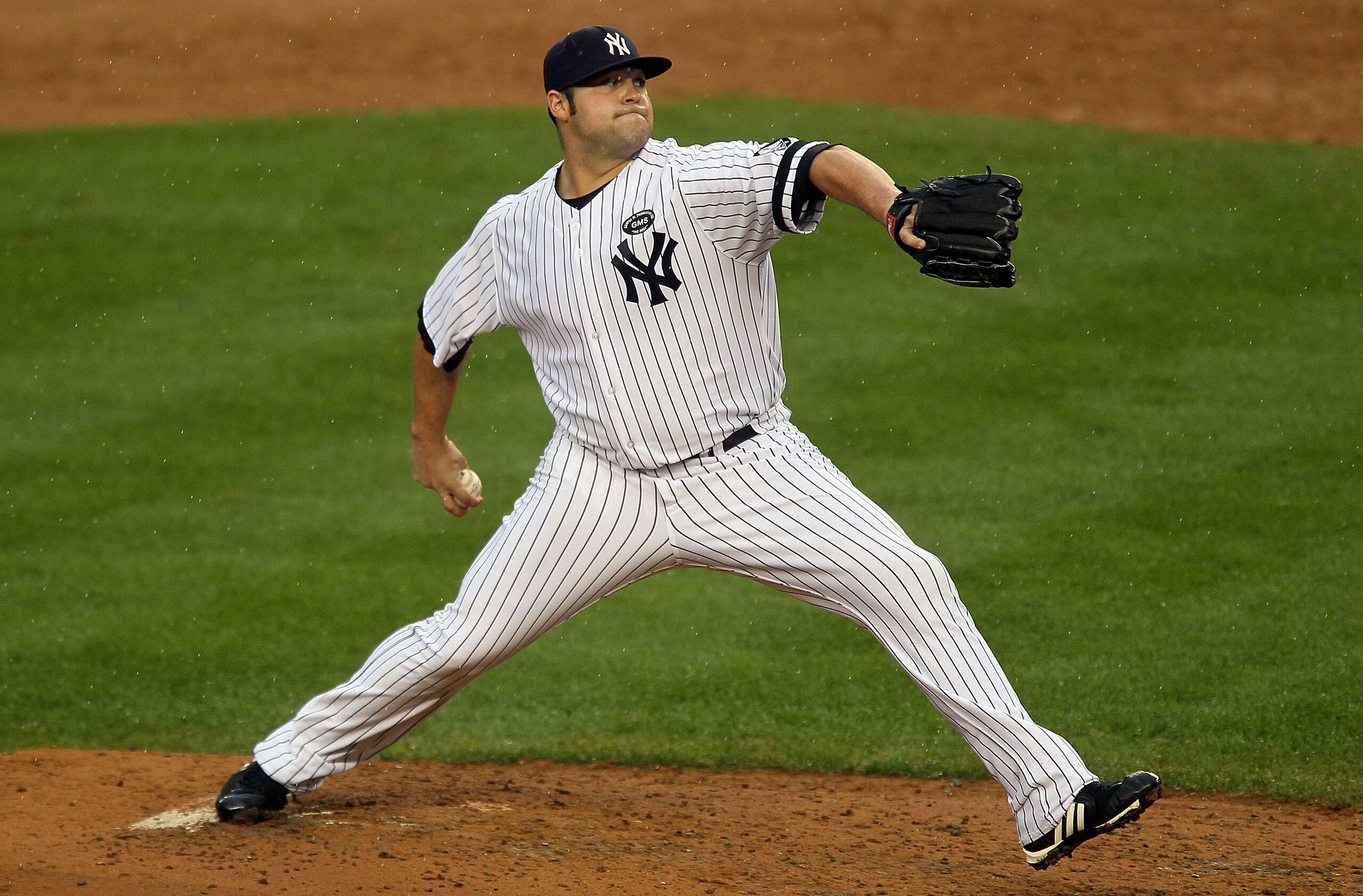 NEW YORK - AUGUST 22:  Joba Chamberlain #62 of the New York Yankees delivers a pitch against the Seattle Mariners on August 22, 2010 at Yankee Stadium in the Bronx borough of New York City.The Yankees defeated the Mariners 10-0.  (Photo by Jim McIsaac/Get