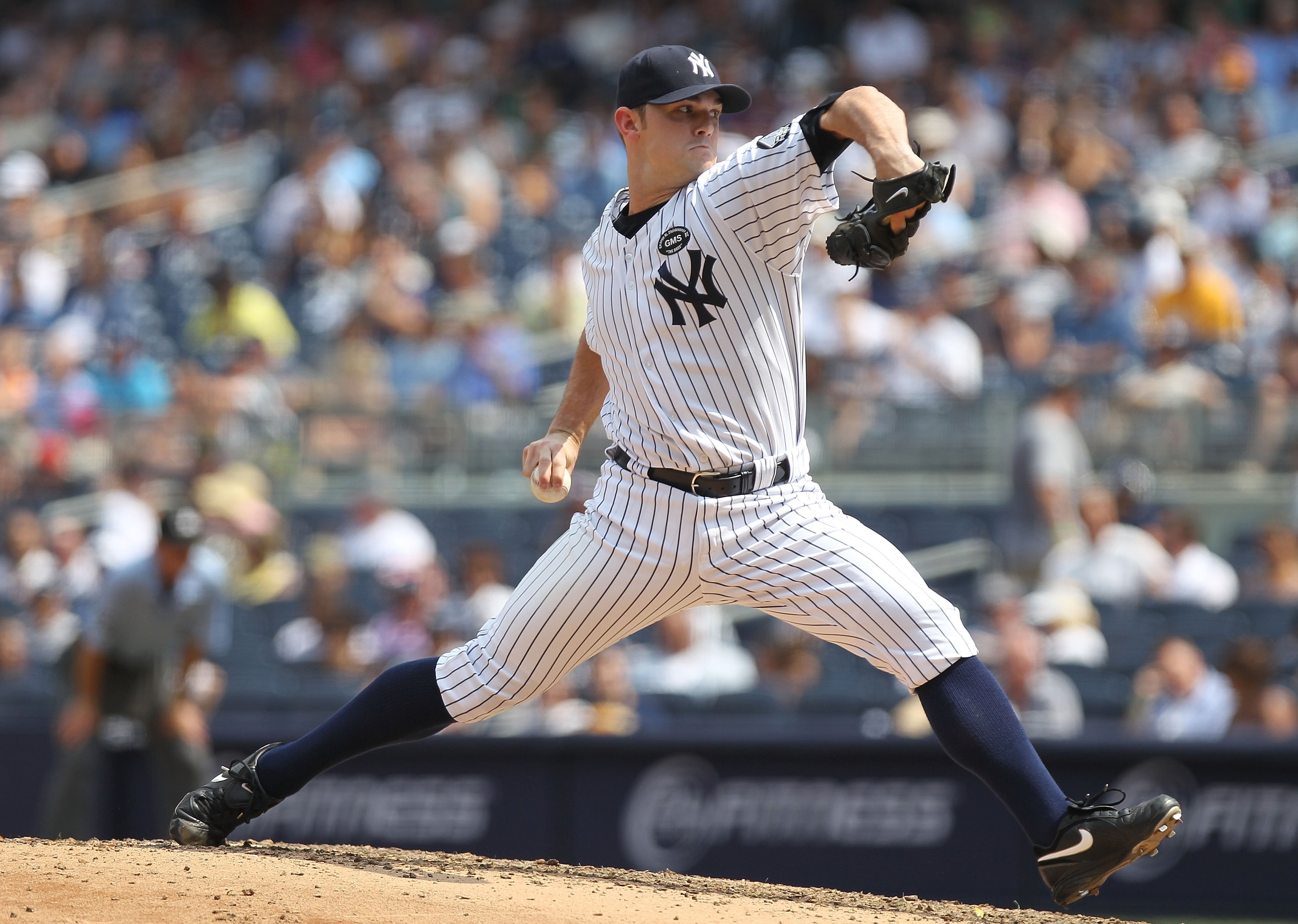 NEW YORK - JULY 21:  David Robertson #30 of the New York Yankees pitches against the Los Angeles Angels of Anaheim at Yankee Stadium on July 21, 2010 in the Bronx borough of New York City.  (Photo by Nick Laham/Getty Images)