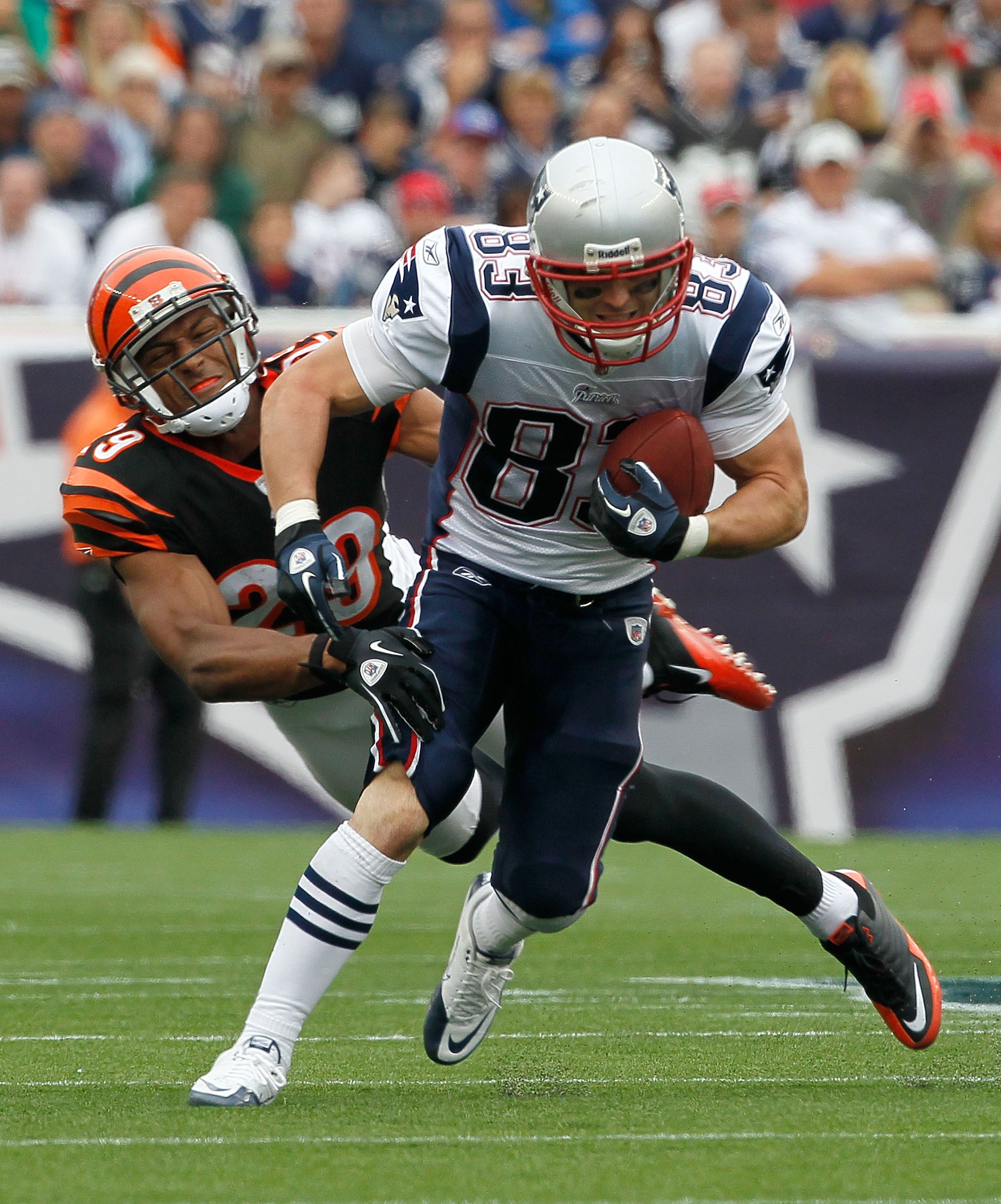 FOXBORO, MA - SEPTEMBER 12:  Wes Welker #83 of the New England Patriots gains yardage despite the defense of Leon Hall #29 of the Cincinnati Bengals during during the NFL season opener at Gillette Stadium on September 12, 2010 in Foxboro, Massachusetts. (