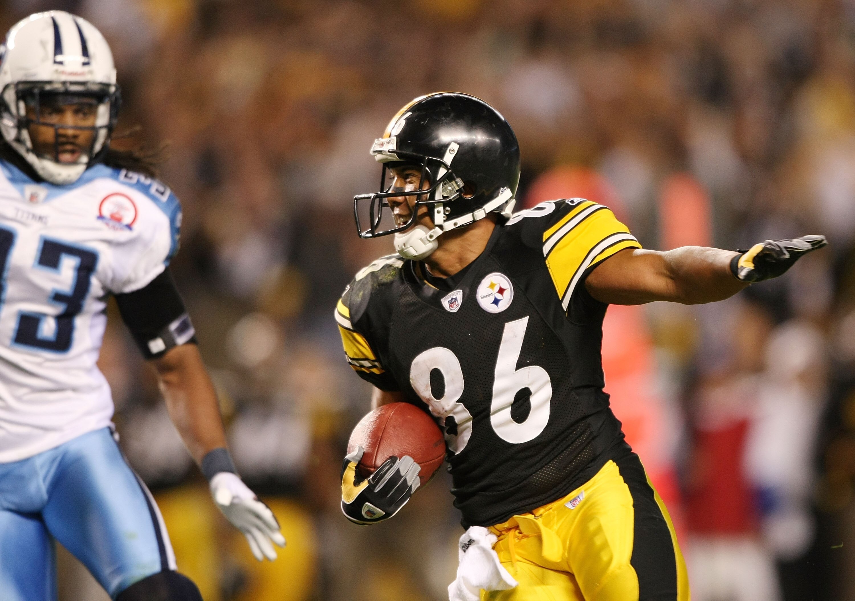 PITTSBURGH - SEPTEMBER 11:   Hines Ward #86 of the Pittsburgh Steelers tries to get around Michael Griffin #33 of the Tennessee Titans on September 11, 2009 at Heinz Field in Pittsburgh, Pennsylvania. The Steelers defeated the Titans 13-10 in overtime.  (
