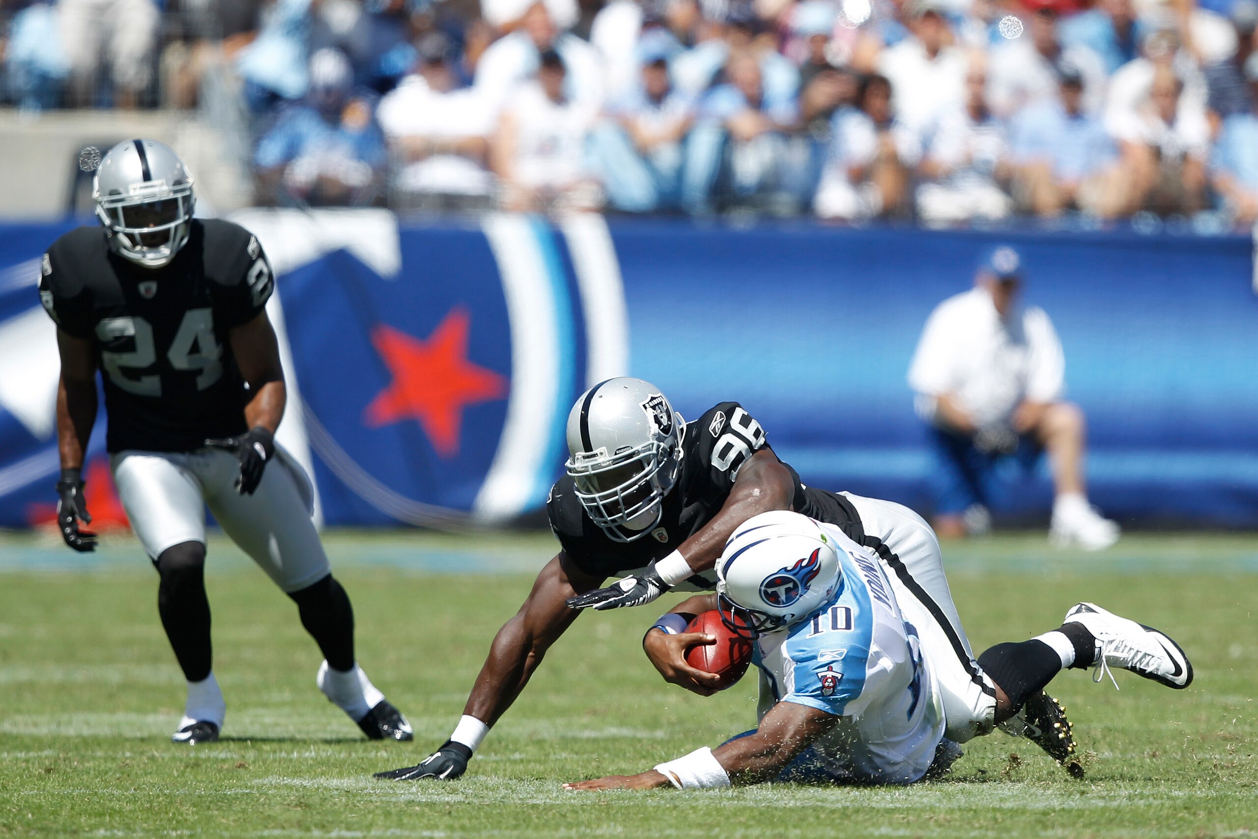 NASHVILLE - SEPTEMBER 12: Kamerion Wimbley #96 of the Oakland Raiders tackles Vince Young #10 of the Tennessee Titans during the NFL season opener at LP Field on September 12, 2010 in Nashville, Tennessee. The Titans defeated the Raiders 38-13. (Photo by NASHVILLE - SEPTEMBER 12: Kamerion Wimbley #96 of the Oakland Raiders tackles Vince Young #10 of the Tennessee Titans during the NFL season opener at LP Field on September 12, 2010 in Nashville, Tennessee. The Titans defeated the Raiders 38-13. (Photo by
