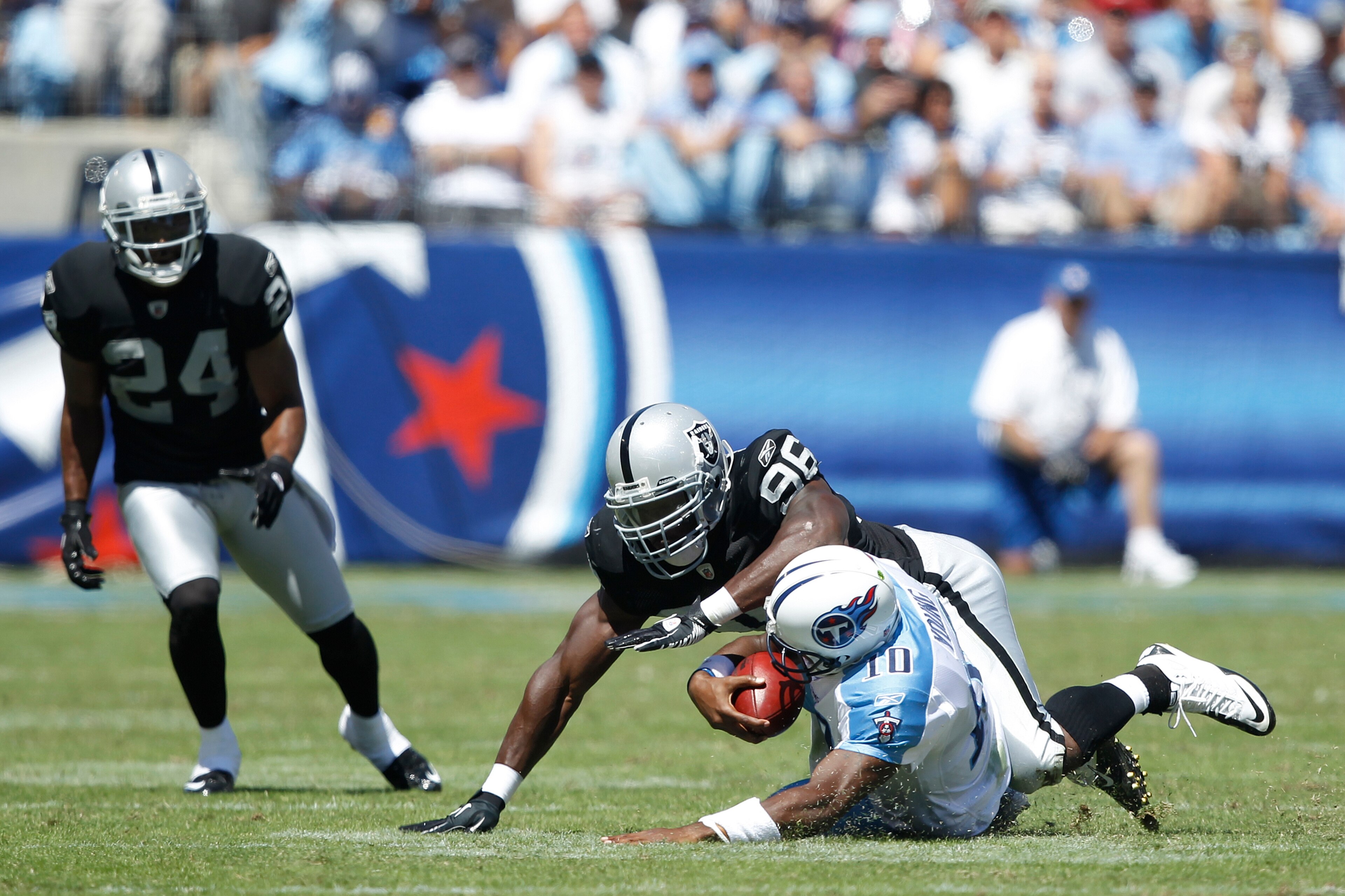 NASHVILLE - SEPTEMBER 12: Kamerion Wimbley #96 of the Oakland Raiders tackles Vince Young #10 of the Tennessee Titans during the NFL season opener at LP Field on September 12, 2010 in Nashville, Tennessee. The Titans defeated the Raiders 38-13. (Photo by 