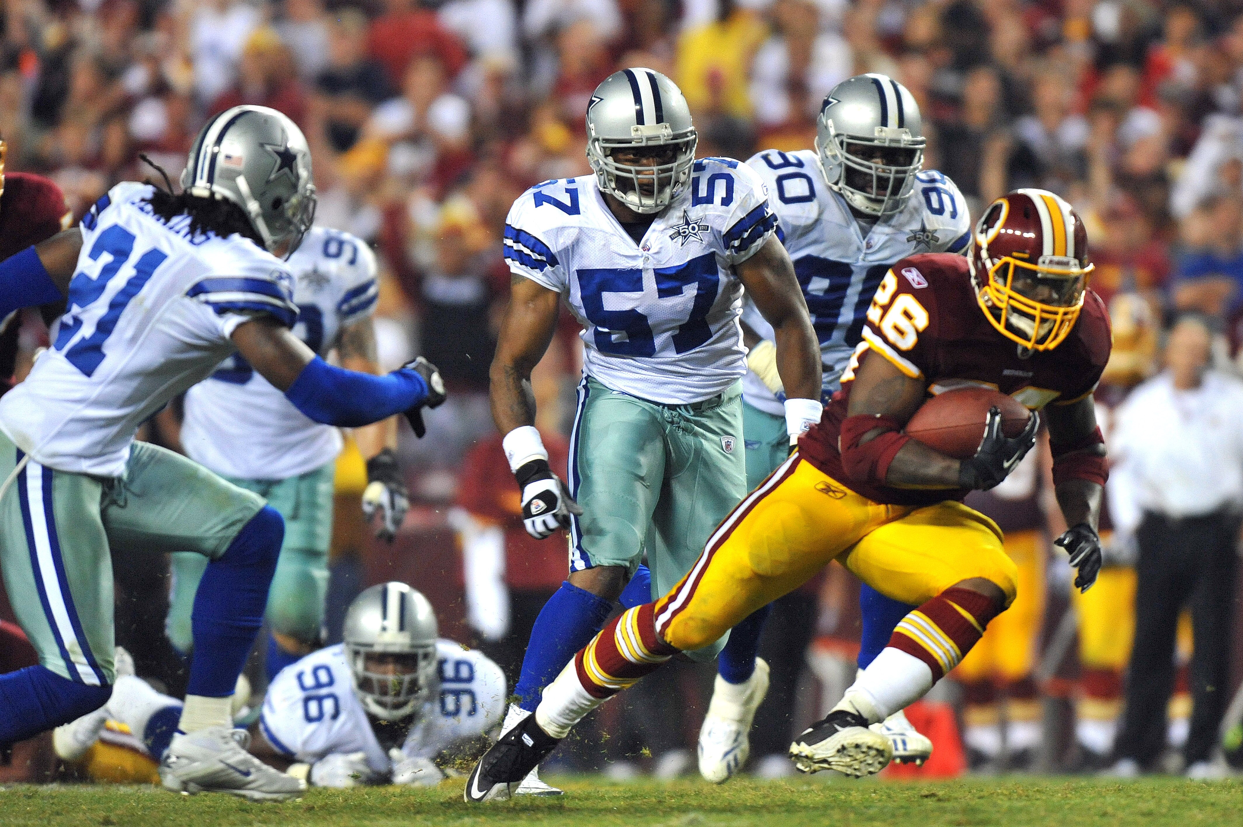 LANDOVER - SEPTEMBER 12:  Clinton Portis #26 of the Washington Redskins runs the ball during the NFL season opener against the Dallas Cowboys at FedExField on September 12, 2010 in Landover, Maryland. The Redskins defeated the Cowboys 13-7. (Photo by Larr