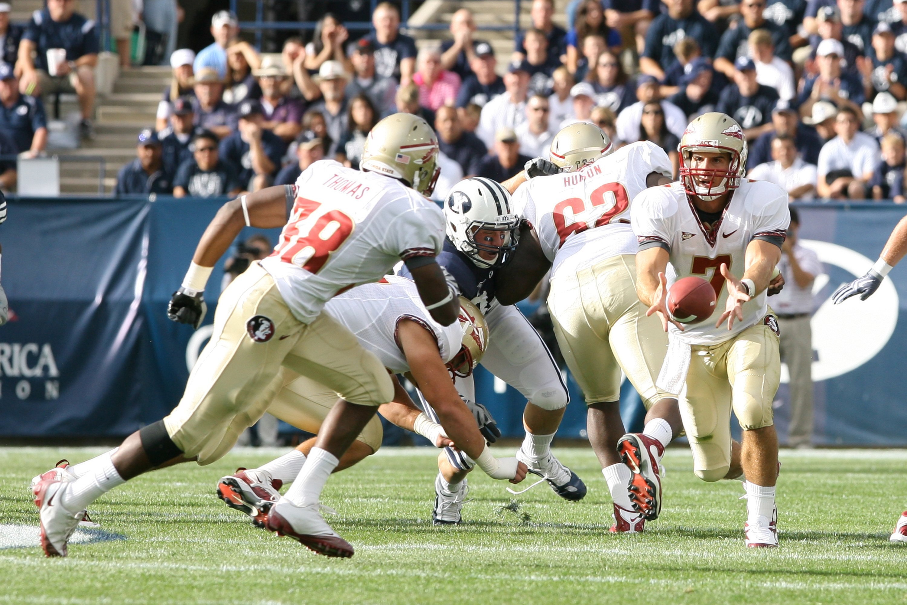 PROVO, UT - SEPTEMBER 19:  Christian Ponder #7 of Florida State Seminoles passes the football to teammate Jermaine Thomas #38 during the game against Brigham Young University Cougars at La Vell Edwards Stadium on September 19, 2009 in Provo, Utah.  (Photo