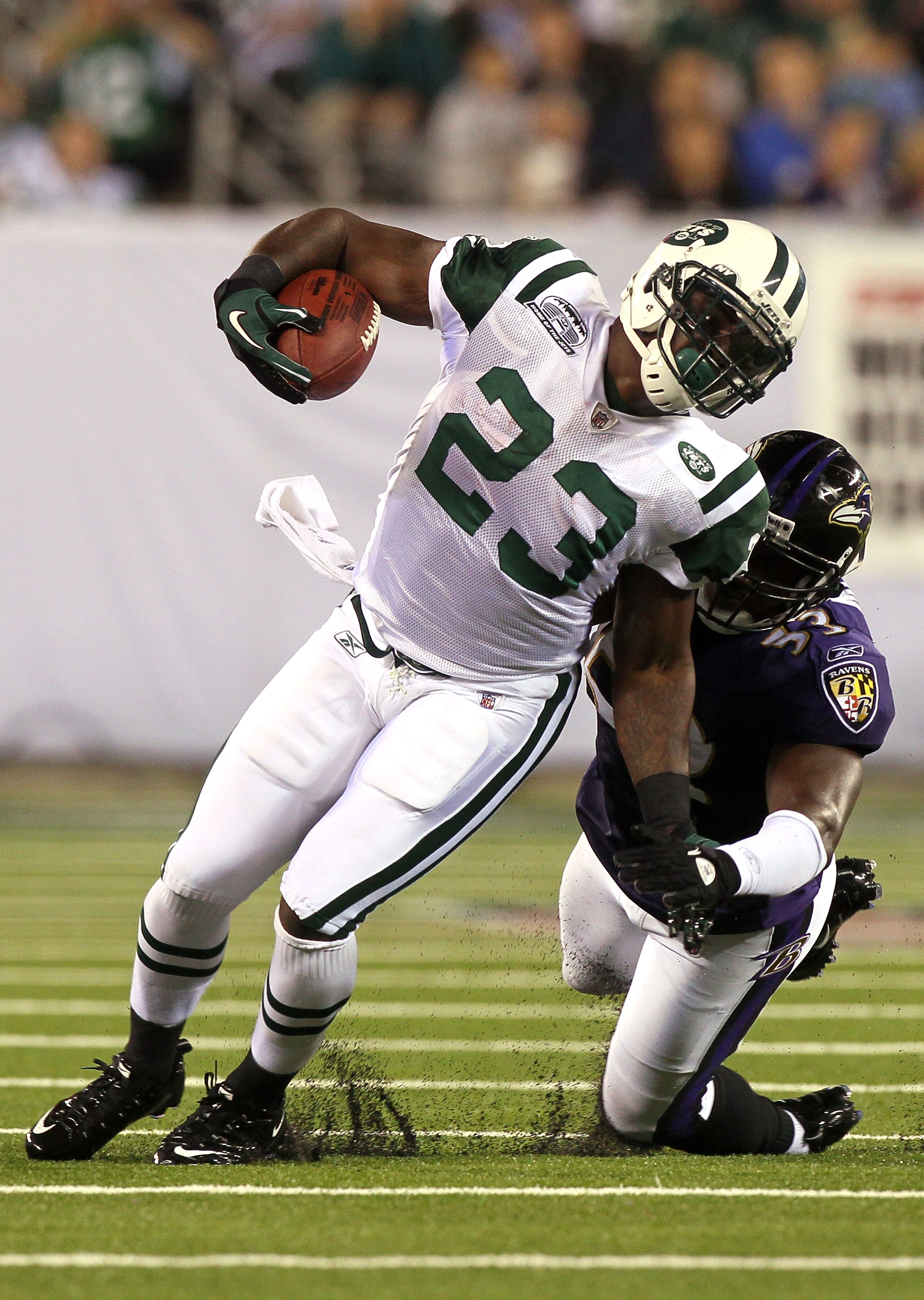 EAST RUTHERFORD, NJ - SEPTEMBER 13:  Shonn Greene #23 of the New York Jets gets tackeled by Jameel McClain #53 of the Baltimore Ravens during their home opener at the New Meadowlands Stadium on September 13, 2010 in East Rutherford, New Jersey.  (Photo by