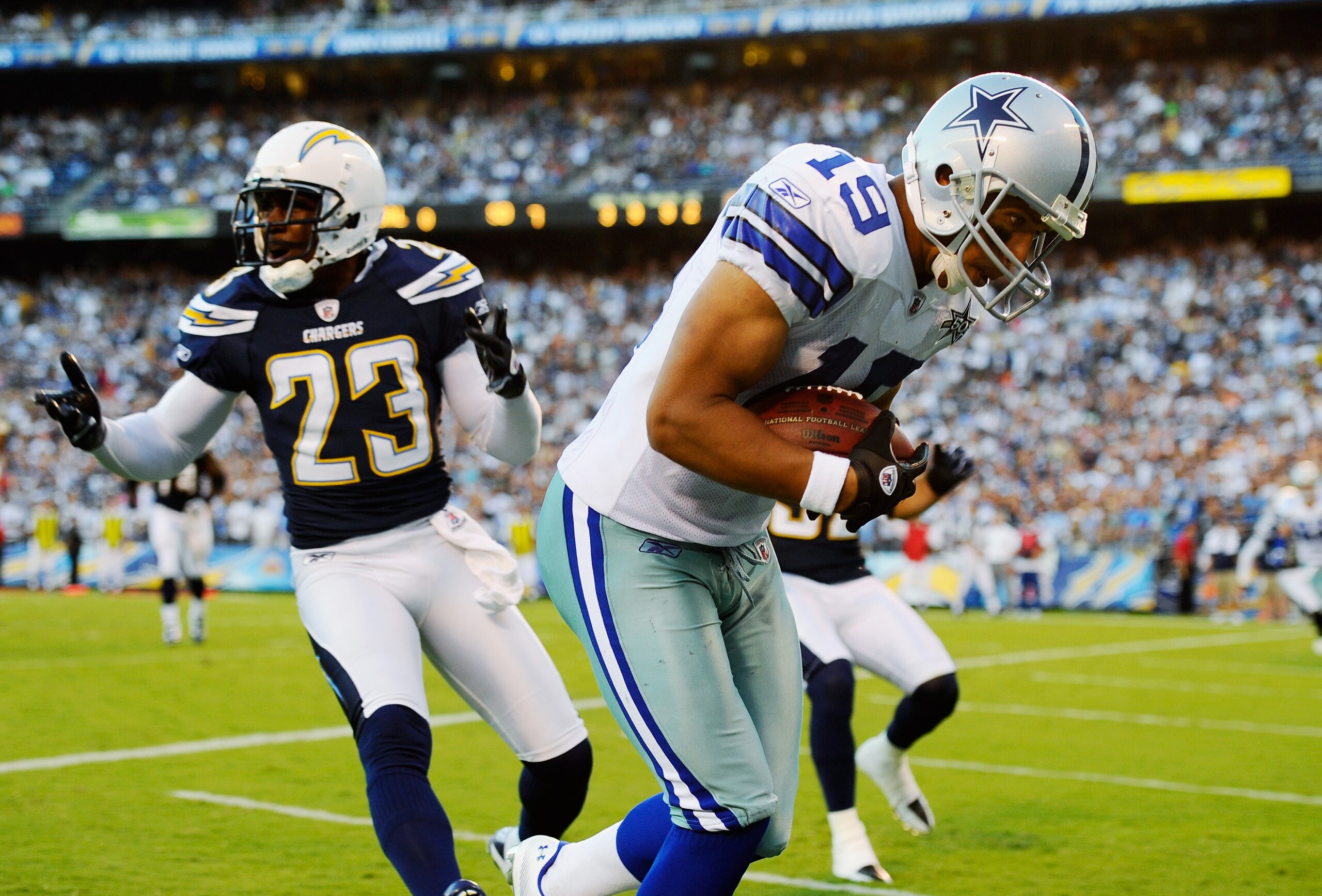 SAN DIEGO - AUGUST 21:  Wide receiver Miles Austin #19 of the Dallas Cowboys catches a touchdown pass against corner back Quentin Jammer #23 of the San Diego Chargers during their preseason NFL football game at Qualcomm Stadium on August 21, 2010 in San D