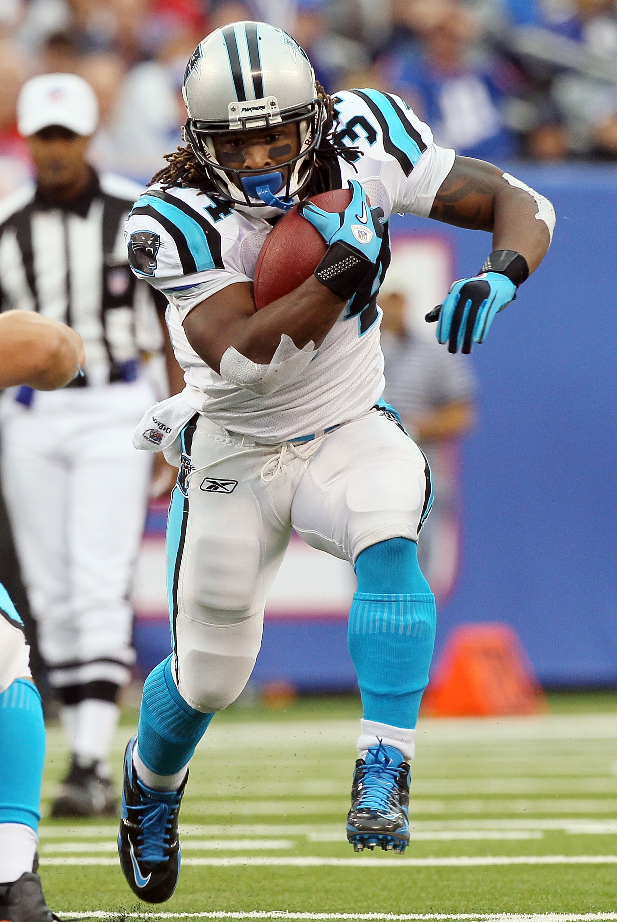 EAST RUTHERFORD, NJ - SEPTEMBER 12:  DeAngelo Williams #34 of the Carolina Panthers runs the ball in the first half against the New York Giants on September 12, 2010 at the New Meadowlands Stadium in East Rutherford, New Jersey.  (Photo by Jim McIsaac/Get