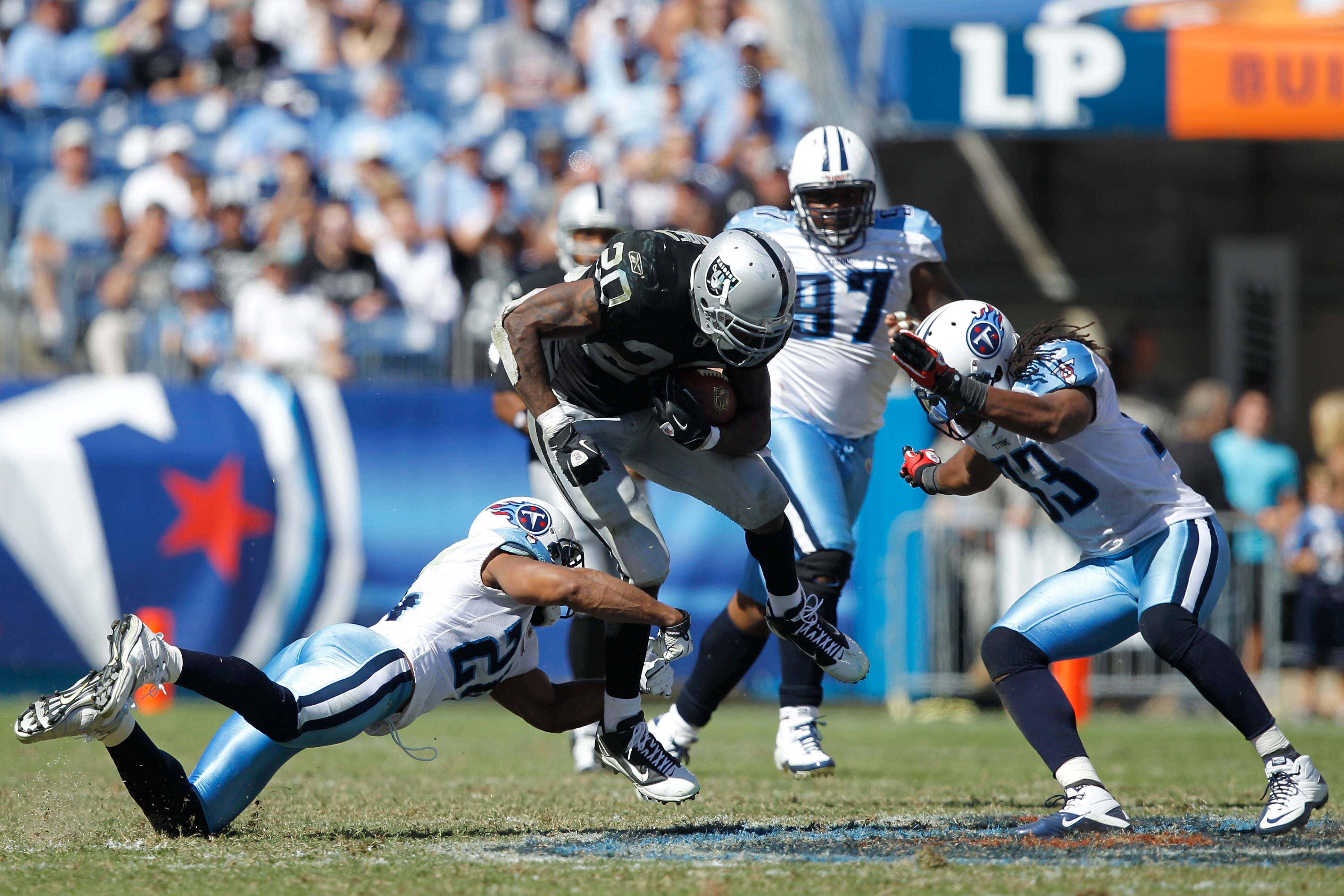 NASHVILLE - SEPTEMBER 12: Michael Griffin #33 and Chris Hope #24 of the Tennessee Titans tackle Darren McFadden #20 of the Oakland Raiders during the NFL season opener at LP Field on September 12, 2010 in Nashville, Tennessee. The Titans defeated the Raid