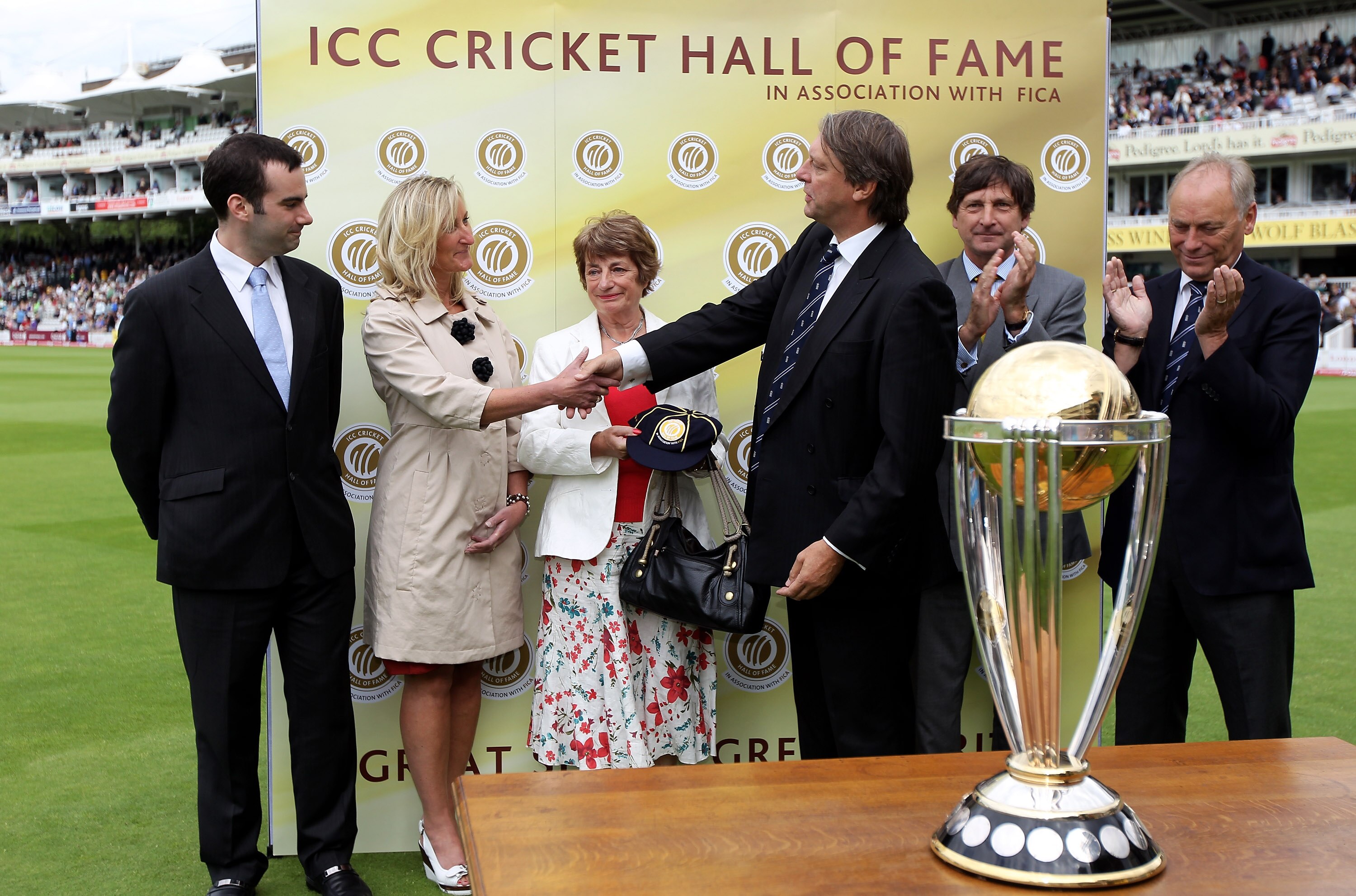 LONDON, ENGLAND - AUGUST 28:  ICC director Giles Clarke (3rdR), MCC President John Barclay (2ndR) and Yorkshire CCC Chairman Colin Graves (R) present a commemorative cap to Herbert Sutcliffe's daughter-in-law Laurel (3rdL) and grandchildren Victoria (2ndL