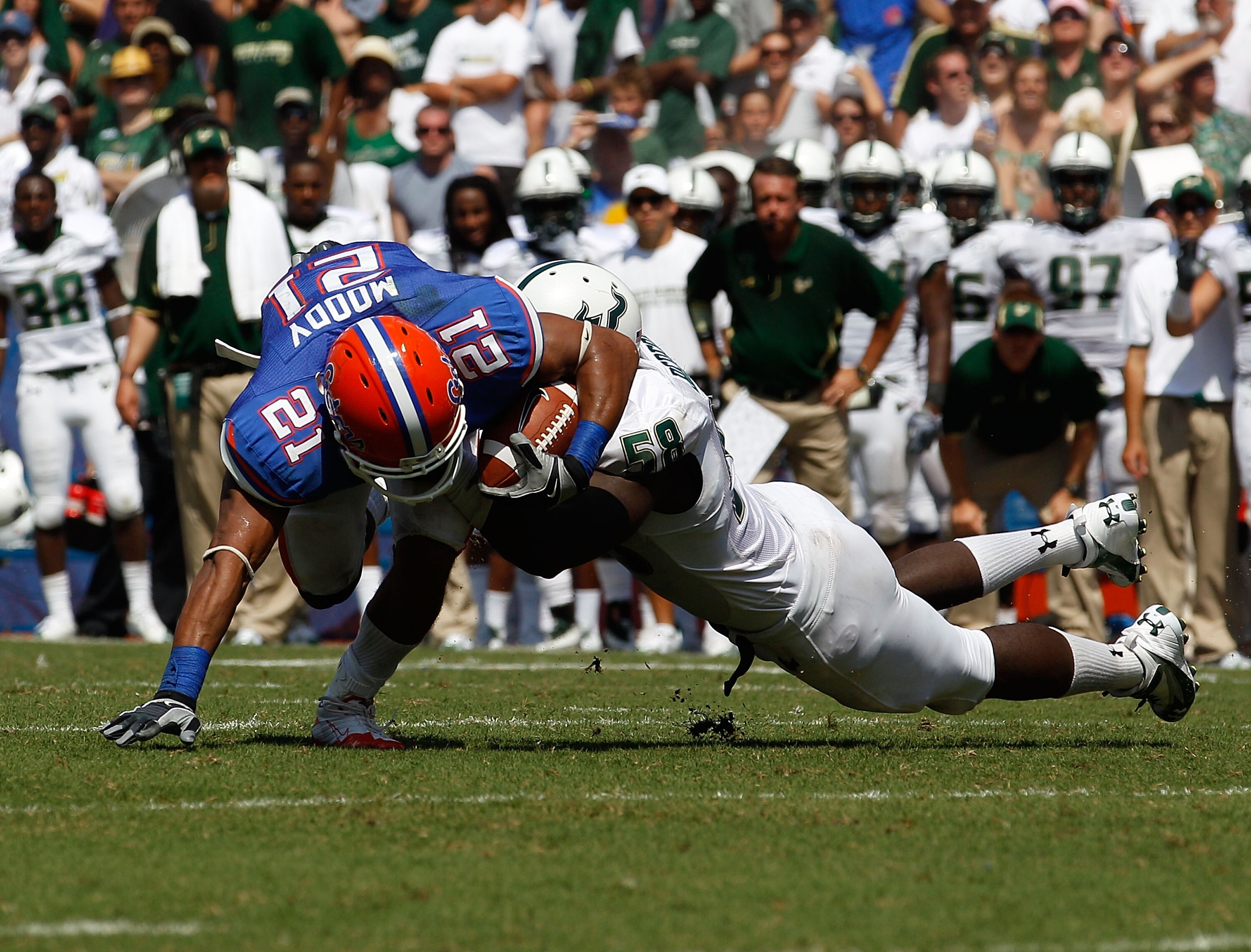GAINESVILLE, FL - SEPTEMBER 11:  Emmanuel Moody #21 of the Florida Gators attempts to run past David Bedford #58 of the South Florida Bulls during a game at Ben Hill Griffin Stadium on September 11, 2010 in Gainesville, Florida.  (Photo by Sam Greenwood/G