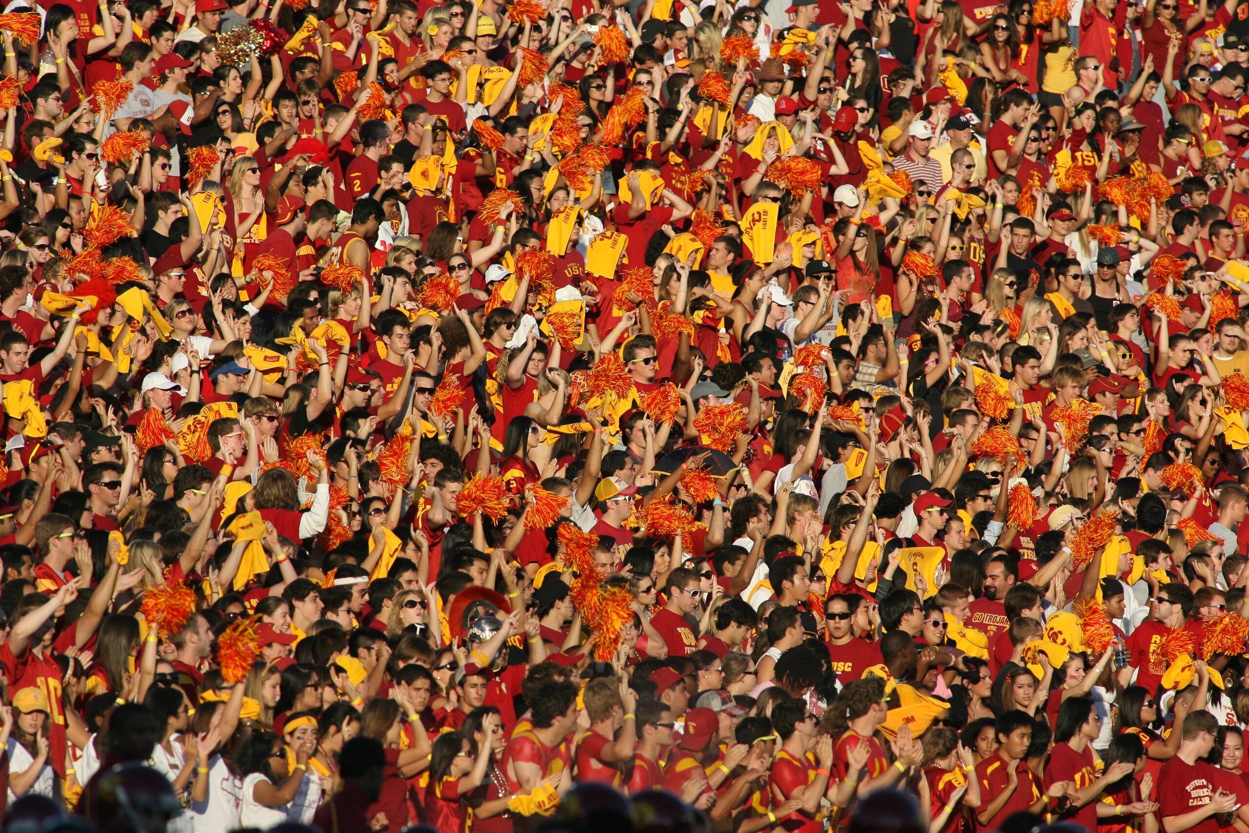 LOS ANGELES, CA - OCTOBER 24:  Fans of the USC Trojans dressed in team colors wave pon pons and yellow towels in the autumn sun during the game against the Oregon State Beavers on October 24, 2009 at the Los Angeles Coliseum in Los Angeles, California.  U