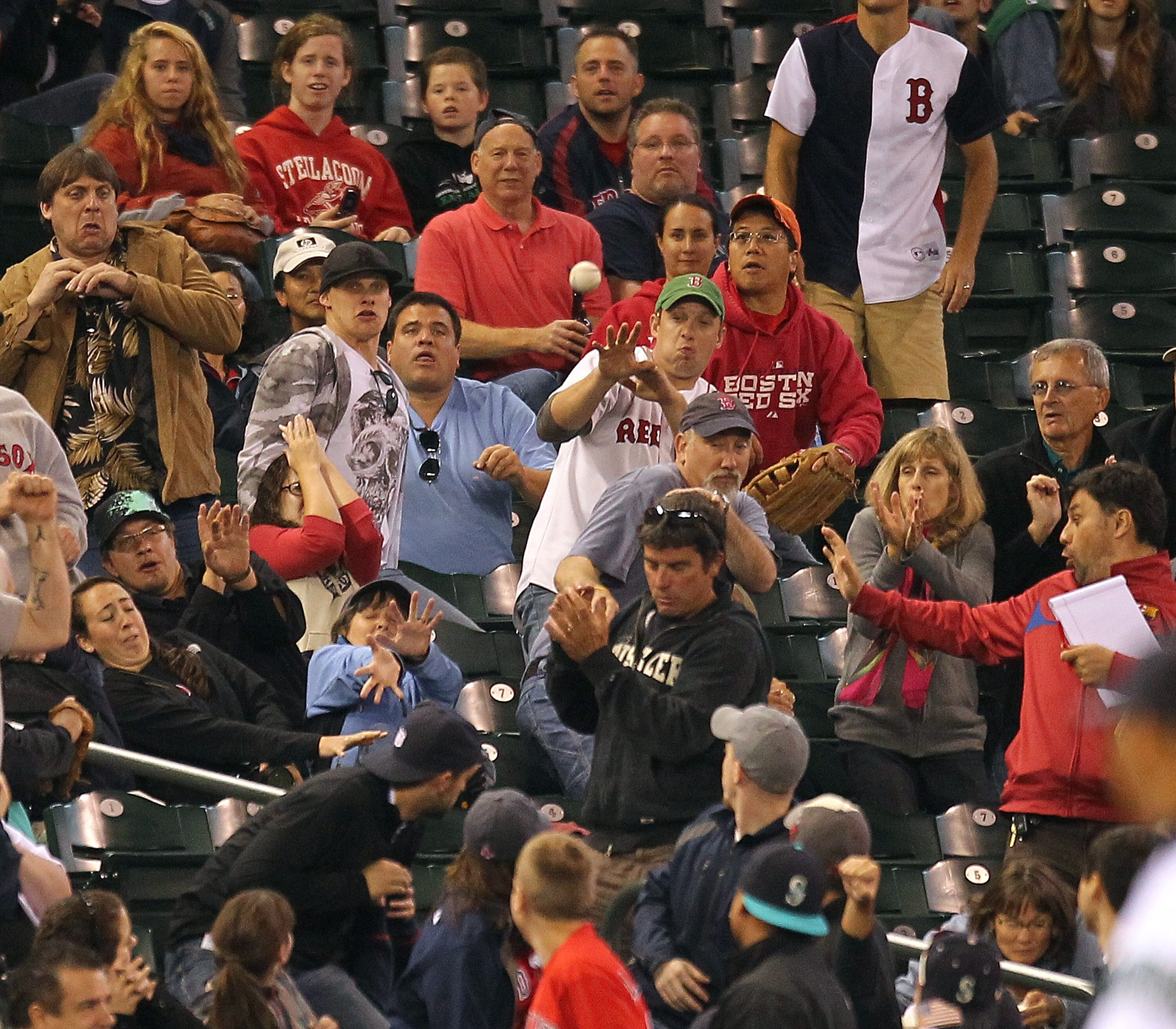 SEATTLE - SEPTEMBER 15:  Fans react to a foul ball by Marco Scutaro #16 of the Boston Red Sox during the game against the Seattle Mariners at Safeco Field on September 15, 2010 in Seattle, Washington. (Photo by Otto Greule Jr/Getty Images)