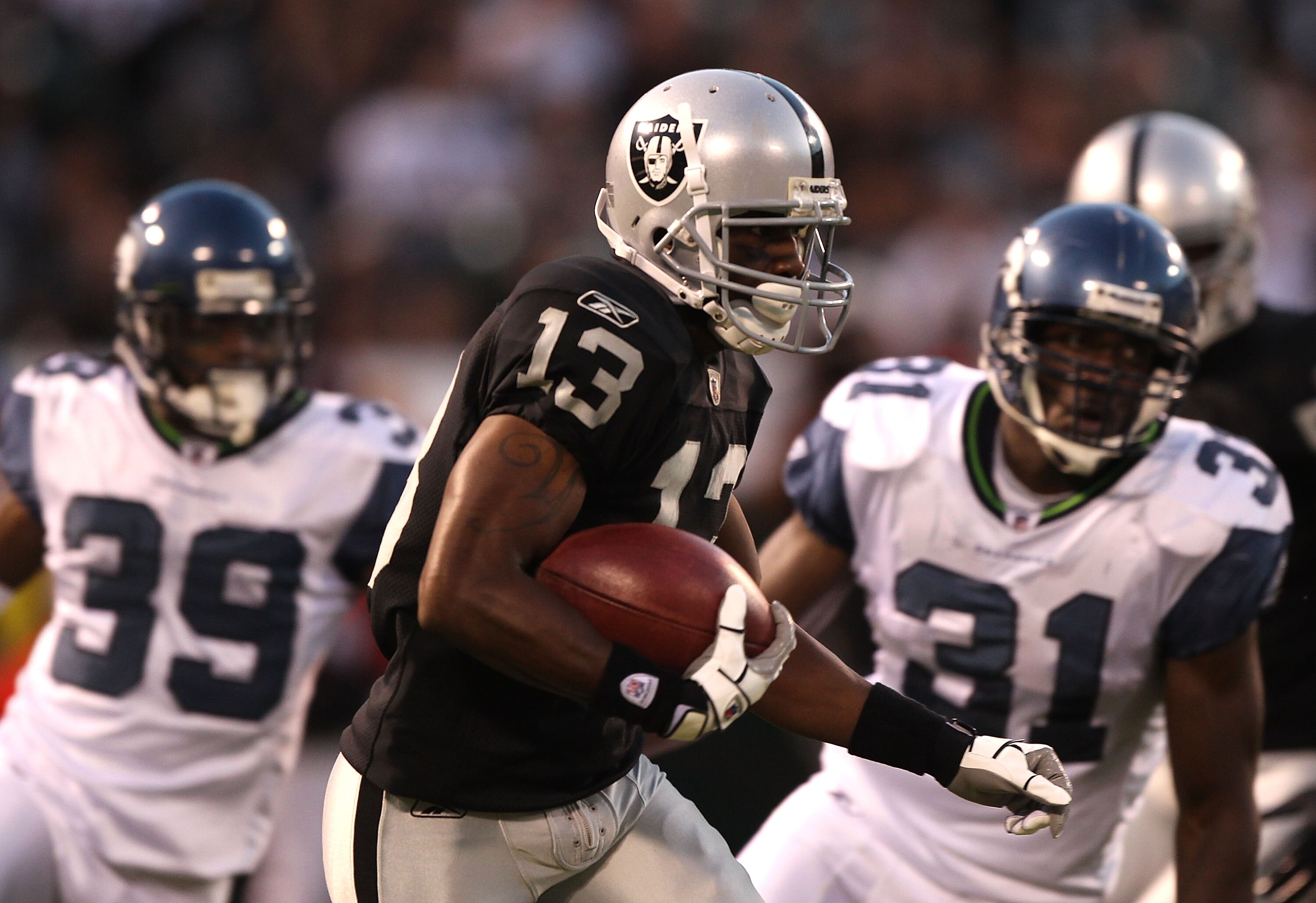 OAKLAND, CA - SEPTEMBER 02: Yamon Figurs #13 of the Oakland Raiders runs against the Seattle Seahawks during an NFL preseason game at Oakland-Alameda County Coliseum on September 2, 2010 in Oakland, California. (Photo by Jed Jacobsohn/Getty Images) OAKLAND, CA - SEPTEMBER 02: Yamon Figurs #13 of the Oakland Raiders runs against the Seattle Seahawks during an NFL preseason game at Oakland-Alameda County Coliseum on September 2, 2010 in Oakland, California. (Photo by Jed Jacobsohn/Getty Images)