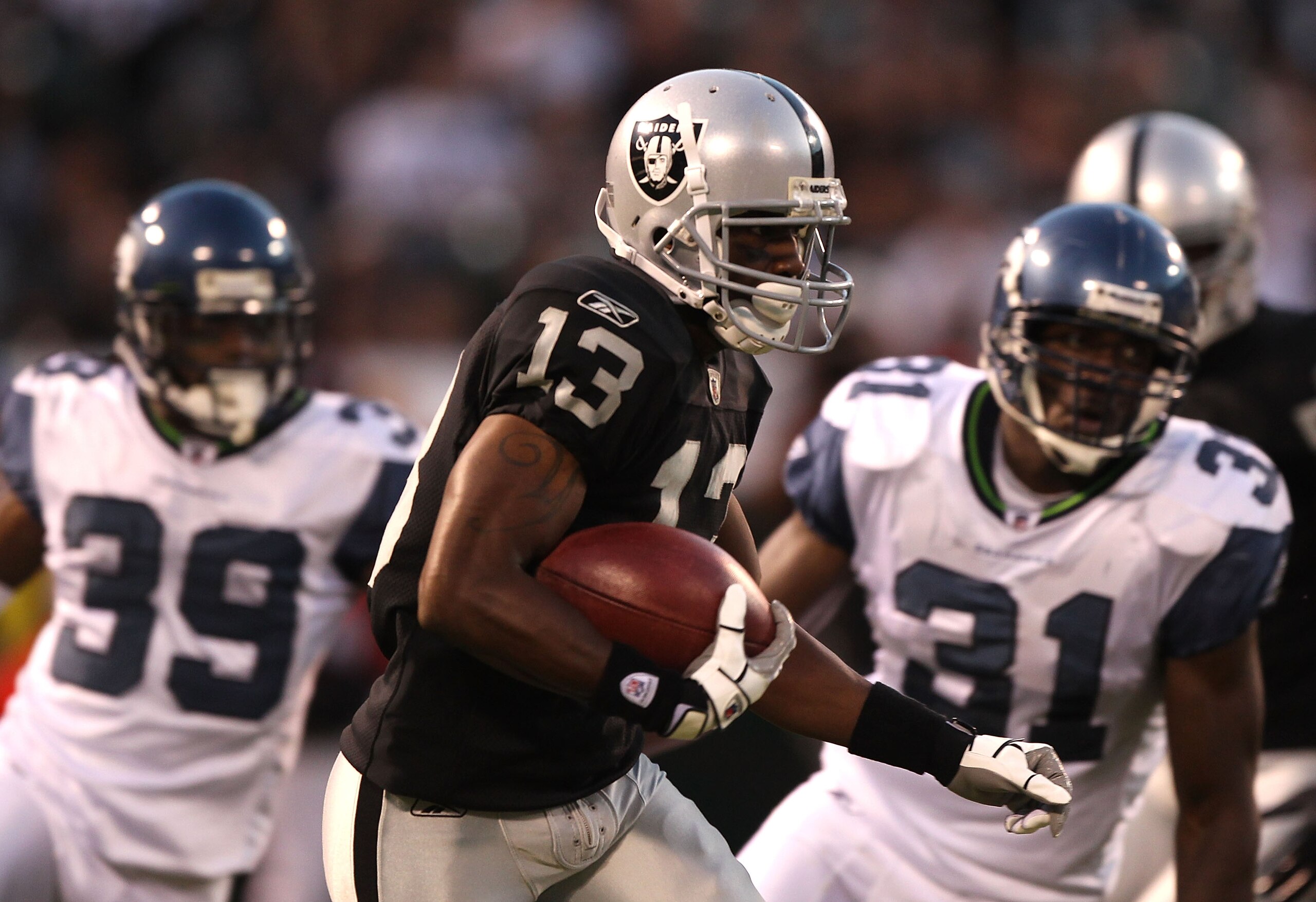 OAKLAND, CA - SEPTEMBER 02: Yamon Figurs #13 of the Oakland Raiders runs against the Seattle Seahawks during an NFL preseason game at Oakland-Alameda County Coliseum on September 2, 2010 in Oakland, California. (Photo by Jed Jacobsohn/Getty Images) OAKLAND, CA - SEPTEMBER 02: Yamon Figurs #13 of the Oakland Raiders runs against the Seattle Seahawks during an NFL preseason game at Oakland-Alameda County Coliseum on September 2, 2010 in Oakland, California. (Photo by Jed Jacobsohn/Getty Images)