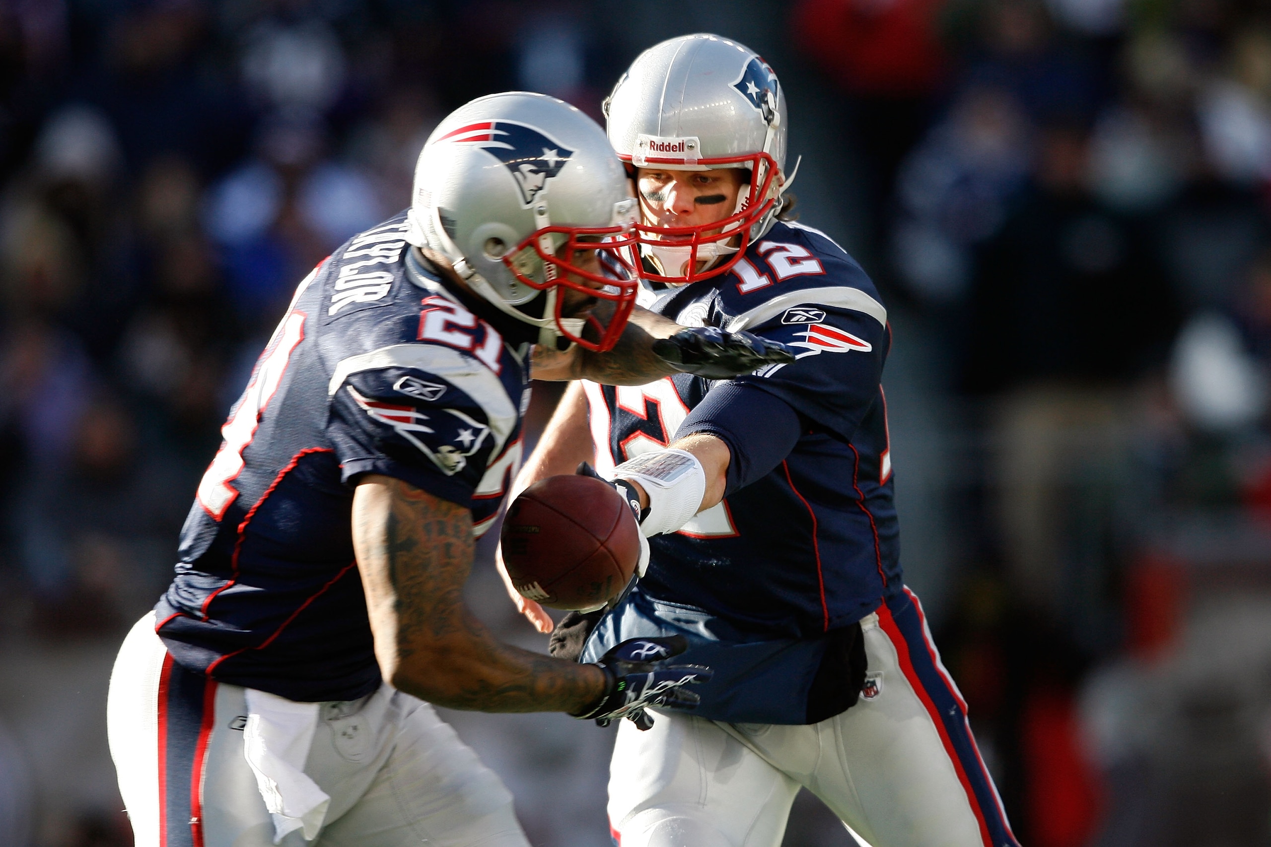 FOXBORO, MA - JANUARY 10:  Tom Brady #12 of the New England Patriots hands the ball off to Fred Taylor #21 against the Baltimore Ravens during the 2010 AFC wild-card playoff game at Gillette Stadium on January 10, 2010 in Foxboro, Massachusetts.  (Photo b