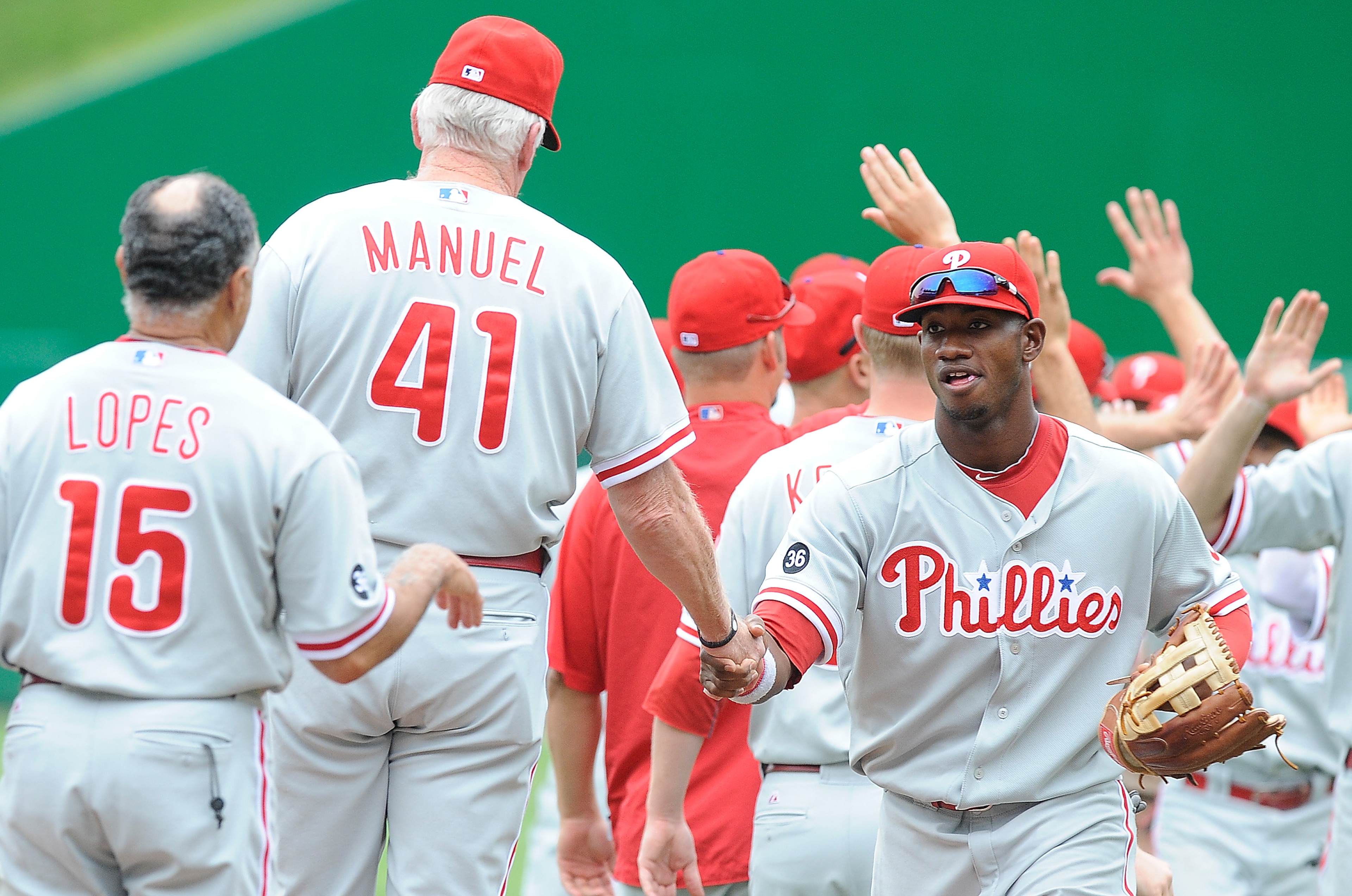 WASHINGTON - AUGUST 01:  Ben Francisco #10 of the Philadelphia Phillies celebrates with manager Charlie Manuel after a 6-4 victory against the Washington Nationals at Nationals Park on August 1, 2010 in Washington, DC.  (Photo by Greg Fiume/Getty Images)