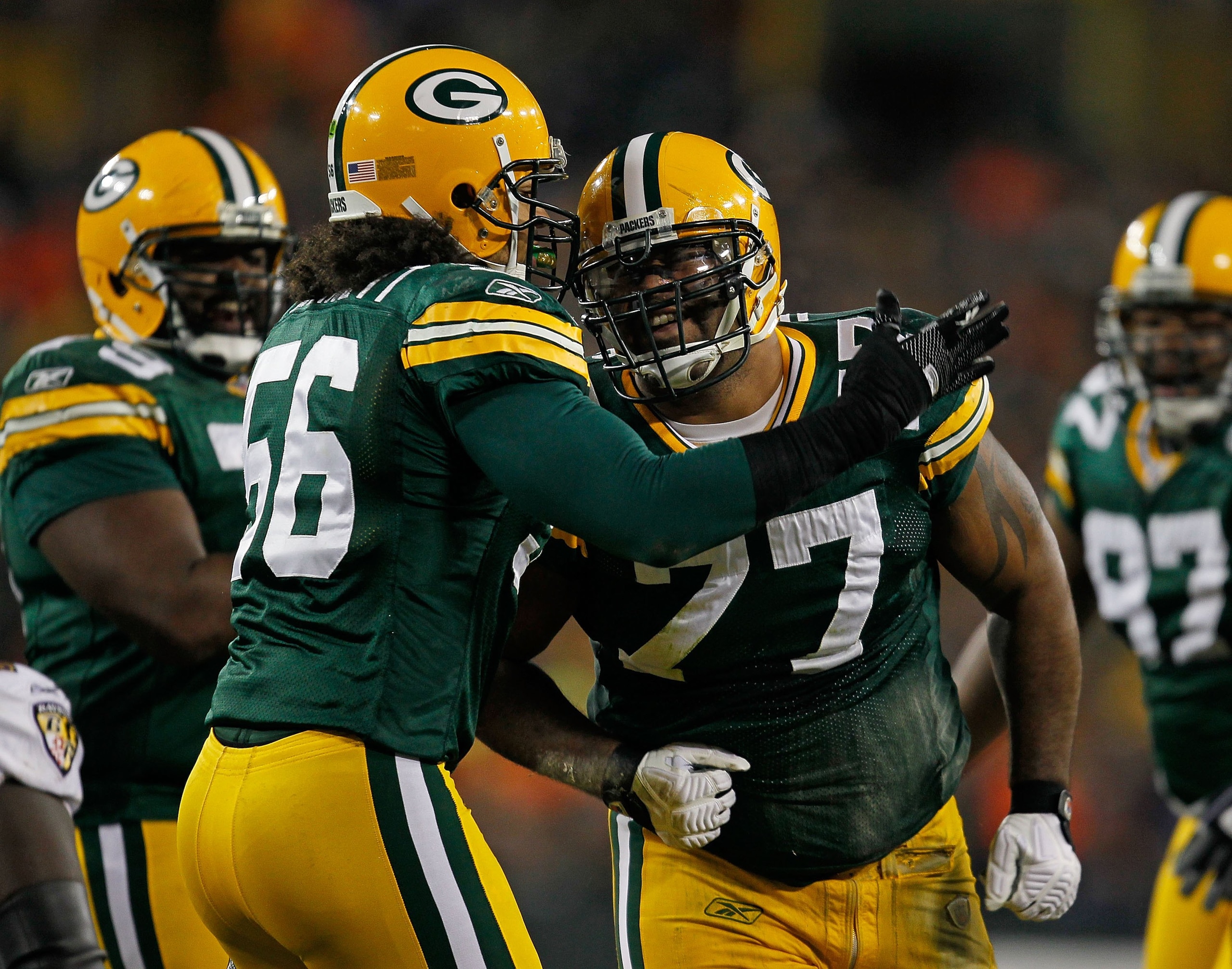GREEN BAY, WI - DECEMBER 07: Nick Barnett #56 of the Green Bay Packers celebrates a defensive play with Cullen Jenkens #77 against the Baltimore Ravens at Lambeau Field on December 7, 2009 in Green Bay, Wisconsin. The Packers defeated the Ravens 27-17. (P