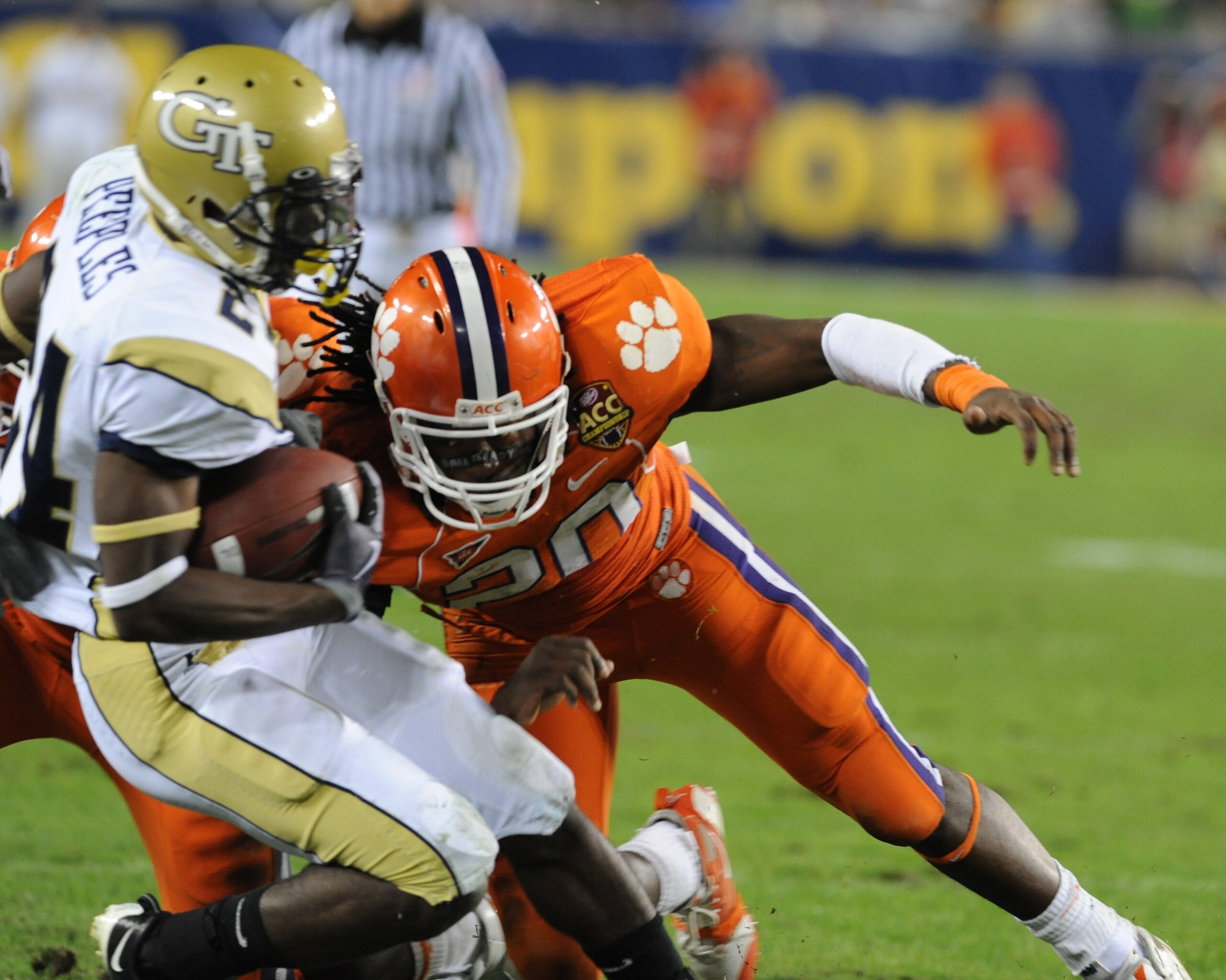 TAMPA, FL - NOVEMBER 28: Linebacker Brandon Maye #20 of the Clemson Tigers tackles running back Embry Peeples #24 of the Georgia Tech Yellow Jackets  in the 2009 ACC Football Championship Game December 5, 2009 at Raymond James Stadium in Tampa, Florida.  