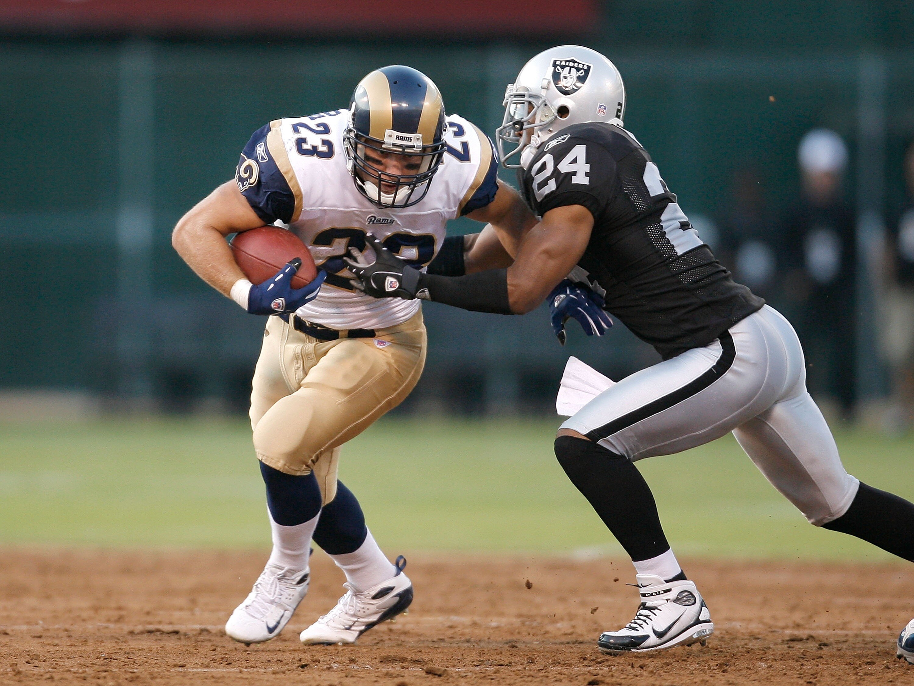 OAKLAND, CA - AUGUST 24:  Running back Brian Leonard #23 of the St. Louis Rams fights for yards as defensive back Michael Huff #24 of the Oakland Raiders tackles him during a preseason game on August 24, 2007 at McAfee Coliseum in Oakland, California.  (P