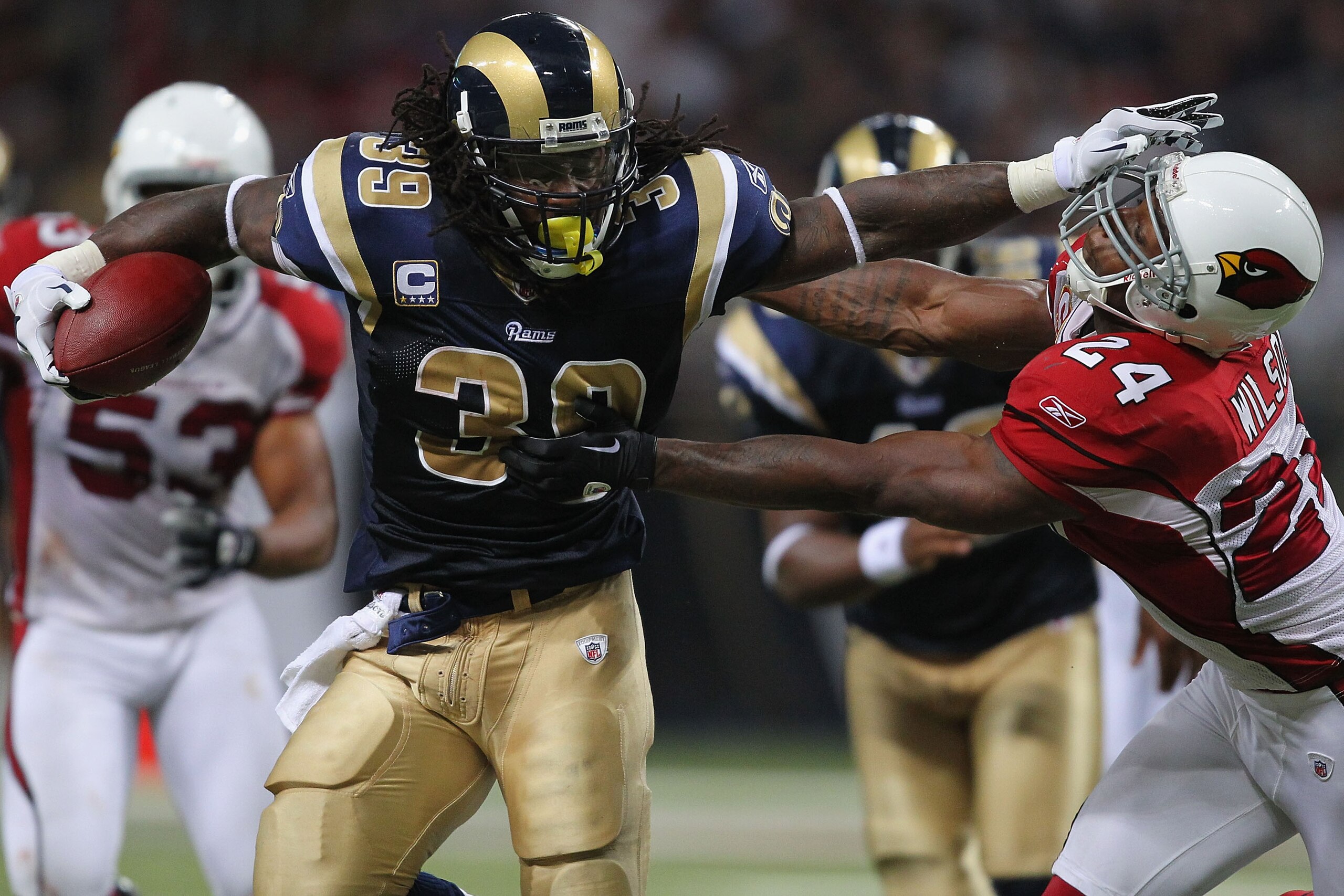 ST. LOUIS - SEPTEMBER 12: Steven Jackson #39 of the St. Louis Rams looks to get past Adrian Wilson #24 of the Arizona Cardinals during the NFL season opener at the Edward Jones Dome on September 12, 2010 in St. Louis, Missouri.  The Cardinals beat the Ram