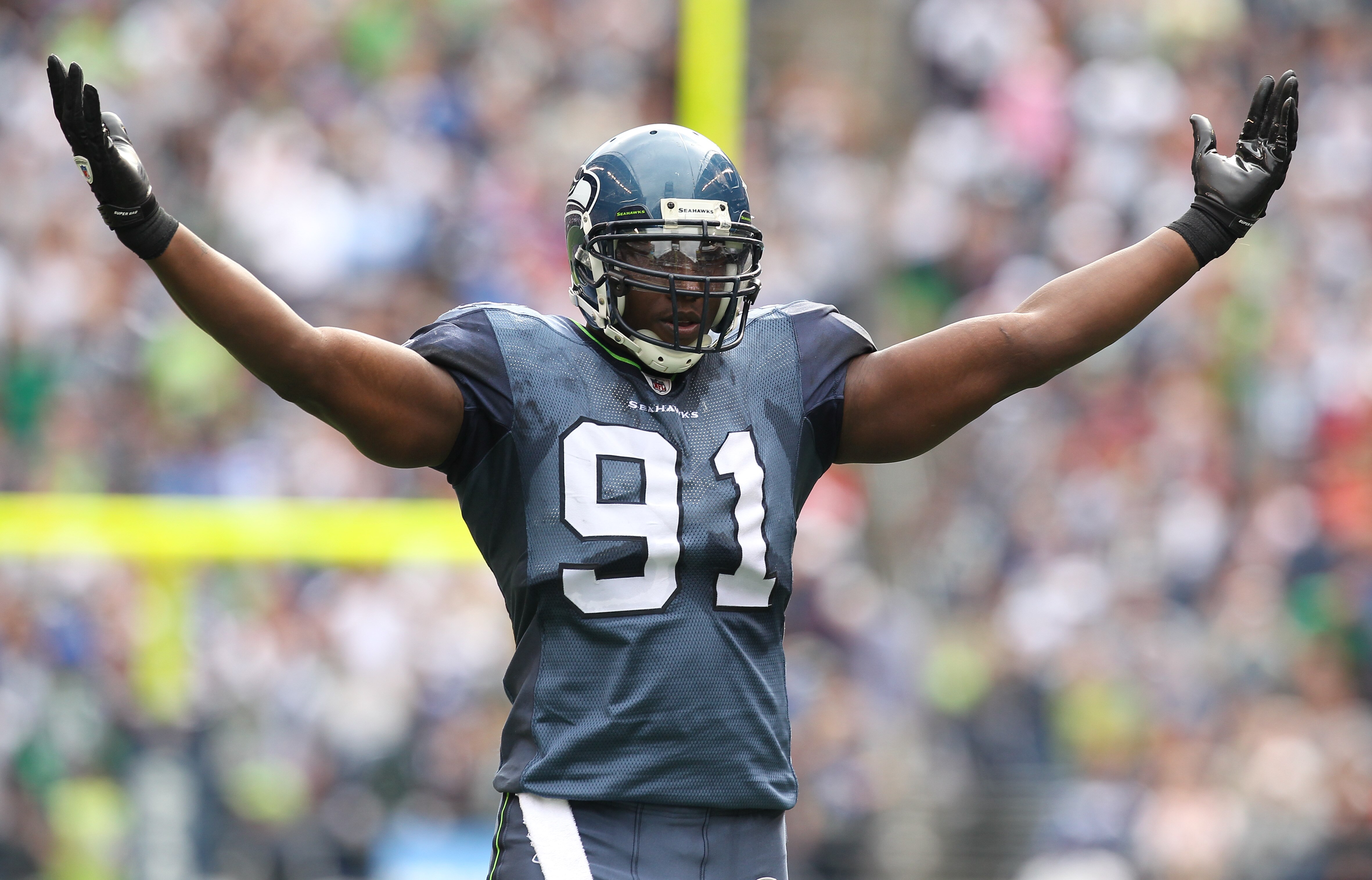 SEATTLE - SEPTEMBER 12:  Defensive end Chris Clemons #91 of the Seattle Seahawks encourages the cheering crowd during the NFL season opener against the San Francisco 49ers at Qwest Field on September 12, 2010 in Seattle, Washington. (Photo by Otto Greule