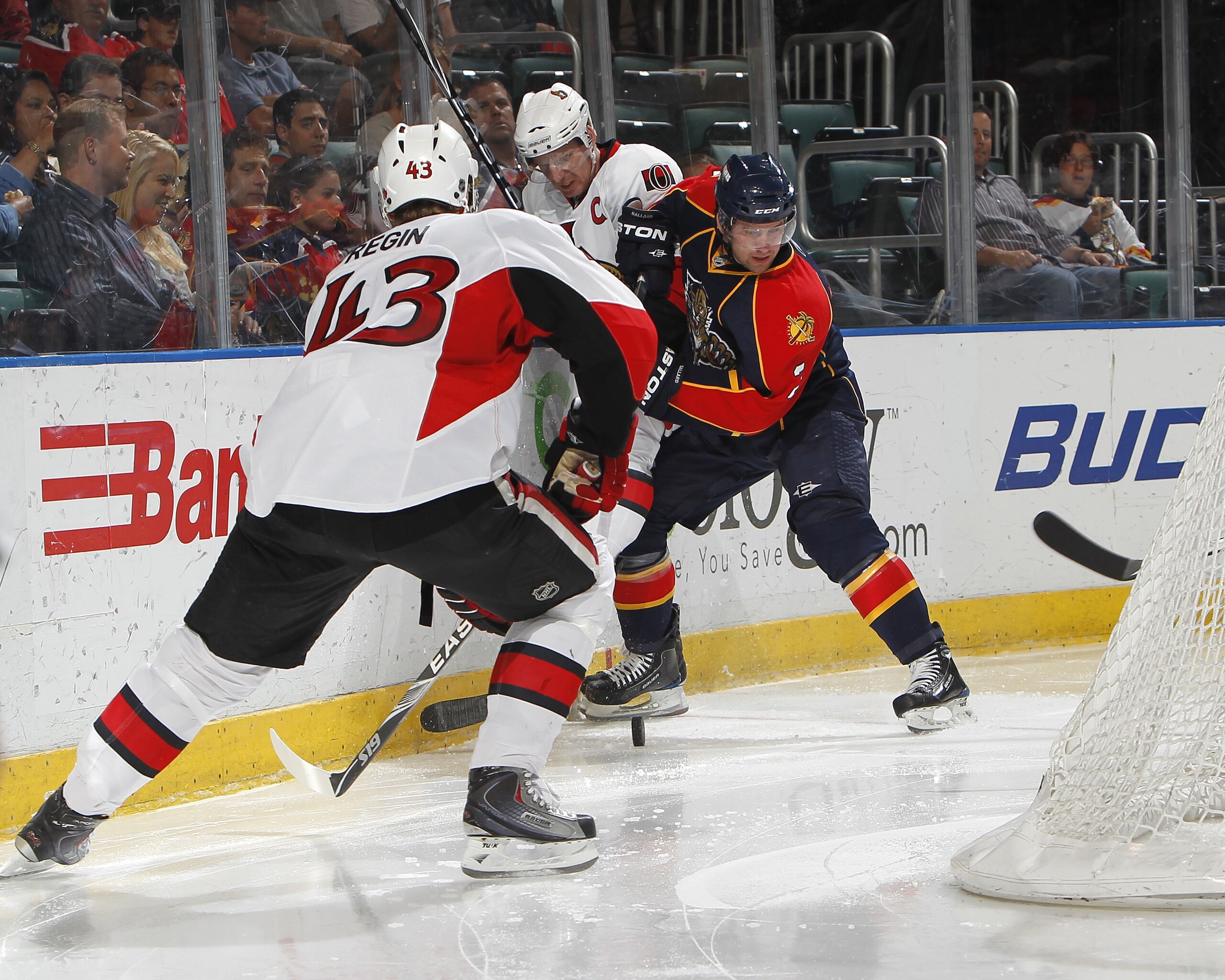 SUNRISE, FL - APRIL 6: Clay Wilson #3 of the Florida Panthers battles behind th enet for the puck with Daniel Alfredsson #11 and Peter Regin #43 of the Ottawa Senators on April 6, 2010 at the BankAtlantic Center in Sunrise, Florida. The Senators defeated 