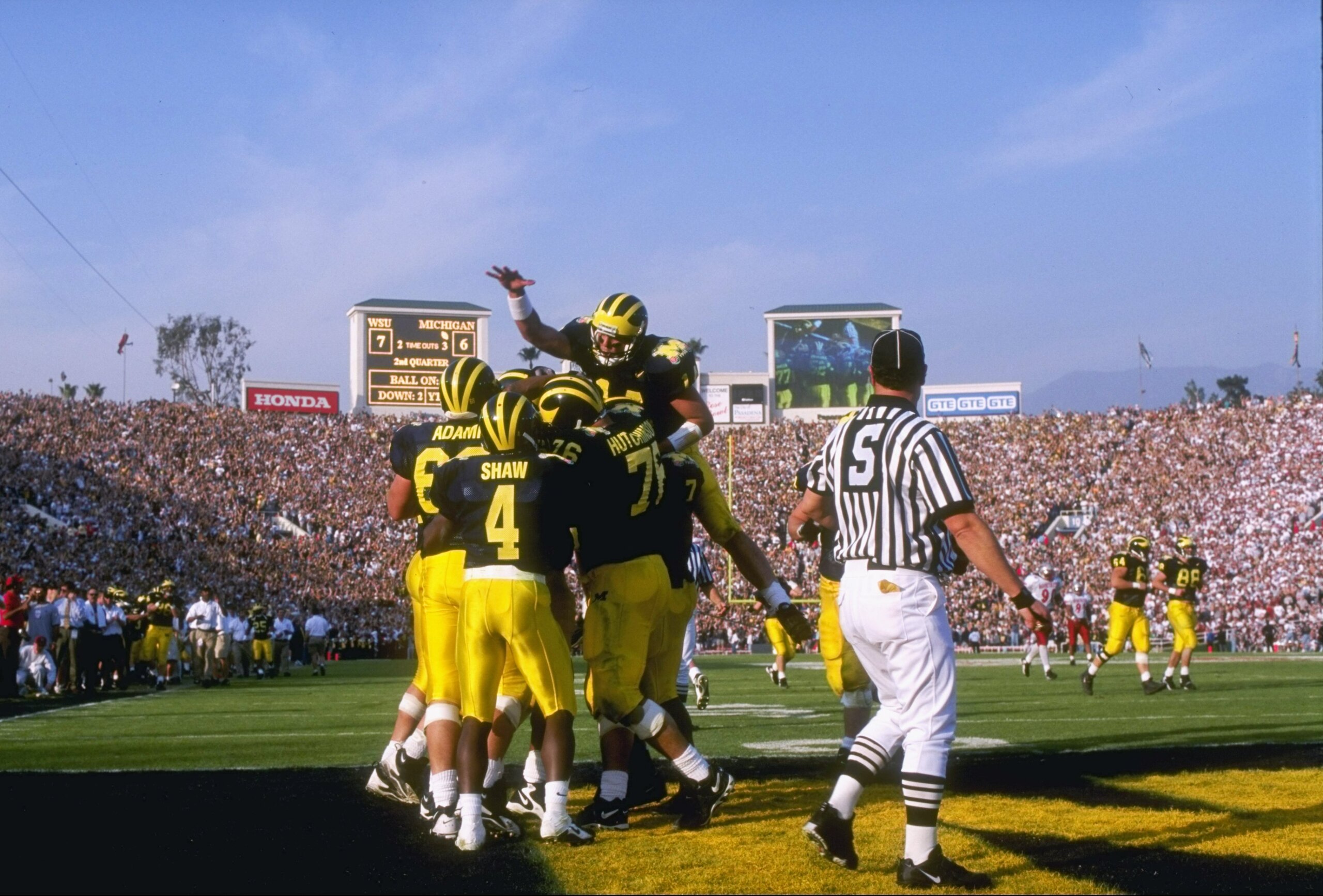 1 Jan 1998:  Quarterback Brian Griese #14 of Michigan leaps onto a pile of teammates after a touchdown during the Wolverines 21-16 win over Washington State in the 1998 Rose Bowl at the Rose Bowl in Pasadena, California. Mandatory Credit: Jed Jacobsohn  /