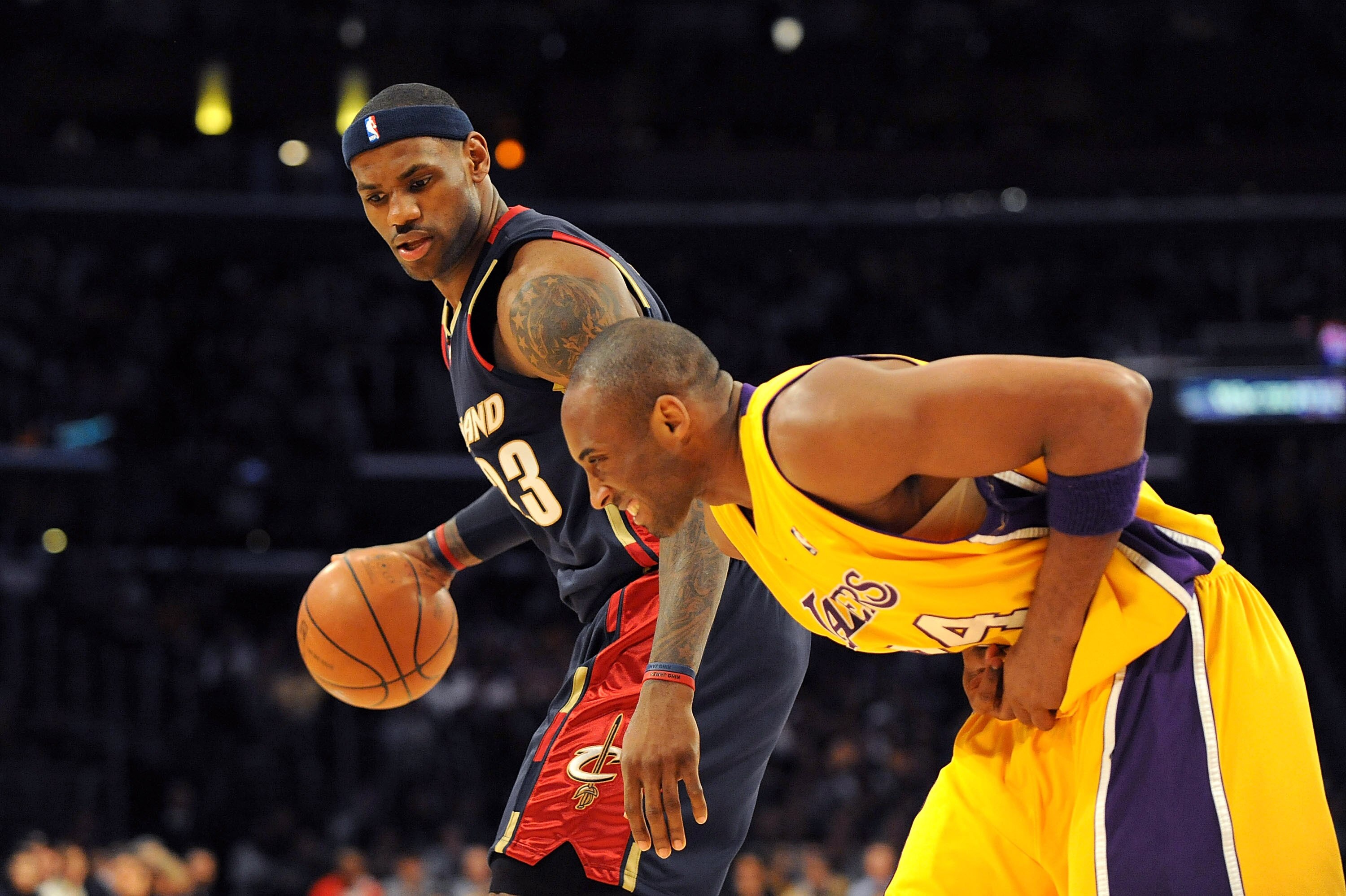 LOS ANGELES, CA - JANUARY 19:  LeBron James #23 of the Cleveland Cavaliers drives the ball against  Kobe Bryant #24 of the Los Angeles Lakers as Kobe  hunches over after he injures his hand during the first quarter at Staples Center on January 19, 2009 in