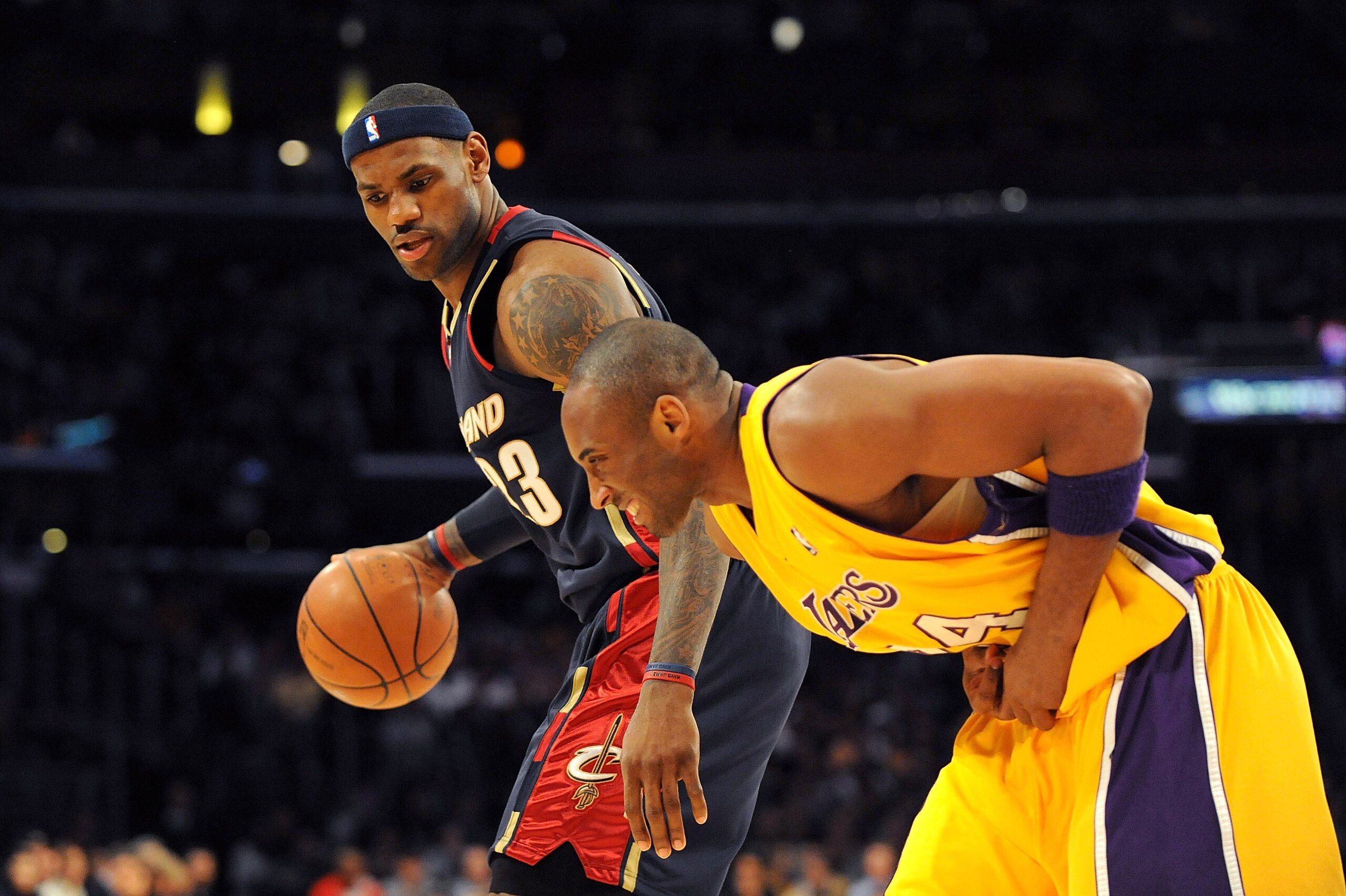 LOS ANGELES, CA - JANUARY 19: LeBron James #23 of the Cleveland Cavaliers drives the ball against Kobe Bryant #24 of the Los Angeles Lakers as Kobe hunches over after he injures his hand during the first quarter at Staples Center on January 19, 2009 in LOS ANGELES, CA - JANUARY 19: LeBron James #23 of the Cleveland Cavaliers drives the ball against Kobe Bryant #24 of the Los Angeles Lakers as Kobe hunches over after he injures his hand during the first quarter at Staples Center on January 19, 2009 in