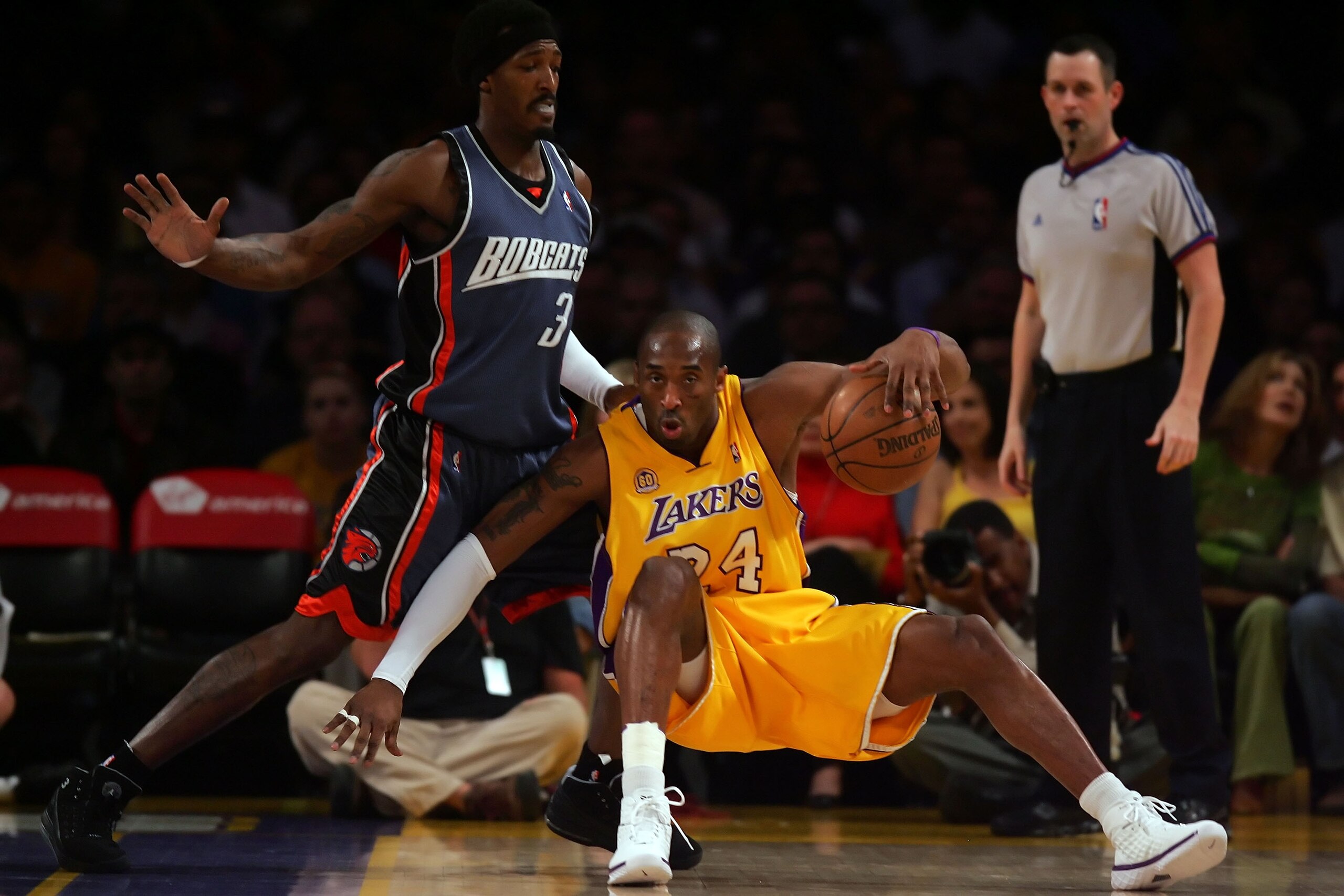 LOS ANGELES, CA - MARCH 26: Kobe Bryant #24 of the Los Angeles Lakers slips while being guarded by Gerald Wallace #3 of the Charlotte Bobcats during the first quarter at Staples Center on March 26, 2008 in Los Angeles, California. NOTE TO USER: User expr LOS ANGELES, CA - MARCH 26: Kobe Bryant #24 of the Los Angeles Lakers slips while being guarded by Gerald Wallace #3 of the Charlotte Bobcats during the first quarter at Staples Center on March 26, 2008 in Los Angeles, California. NOTE TO USER: User expr