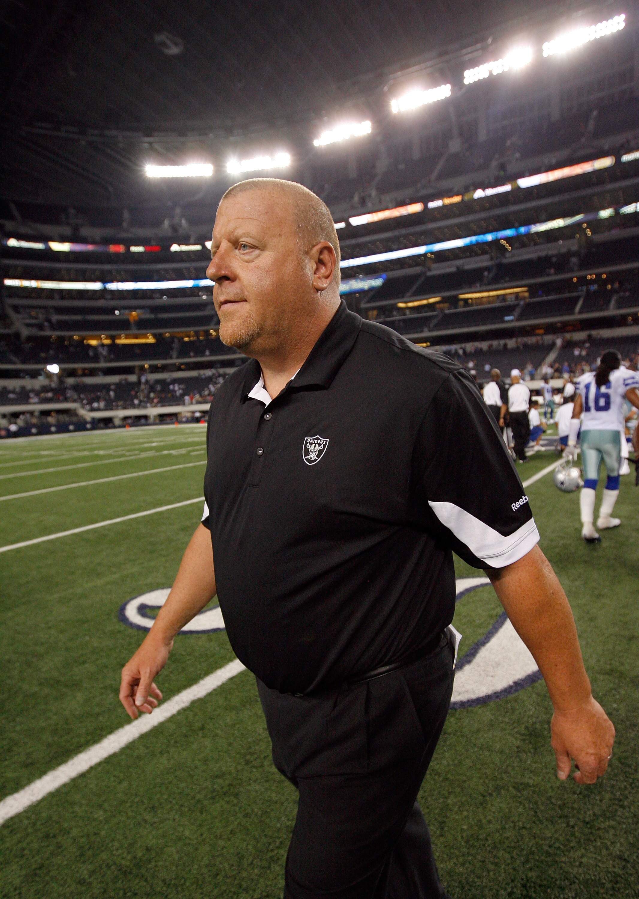 ARLINGTON, TX - AUGUST 12: Tom Cable, head coach of the Oakland Raiders, walks off the field after his team beat the Dallas Cowboys 17-9 at the Dallas Cowboys Stadium on August 12, 2010 in Arlington, Texas. (Photo by Tom Pennington/Getty Images)