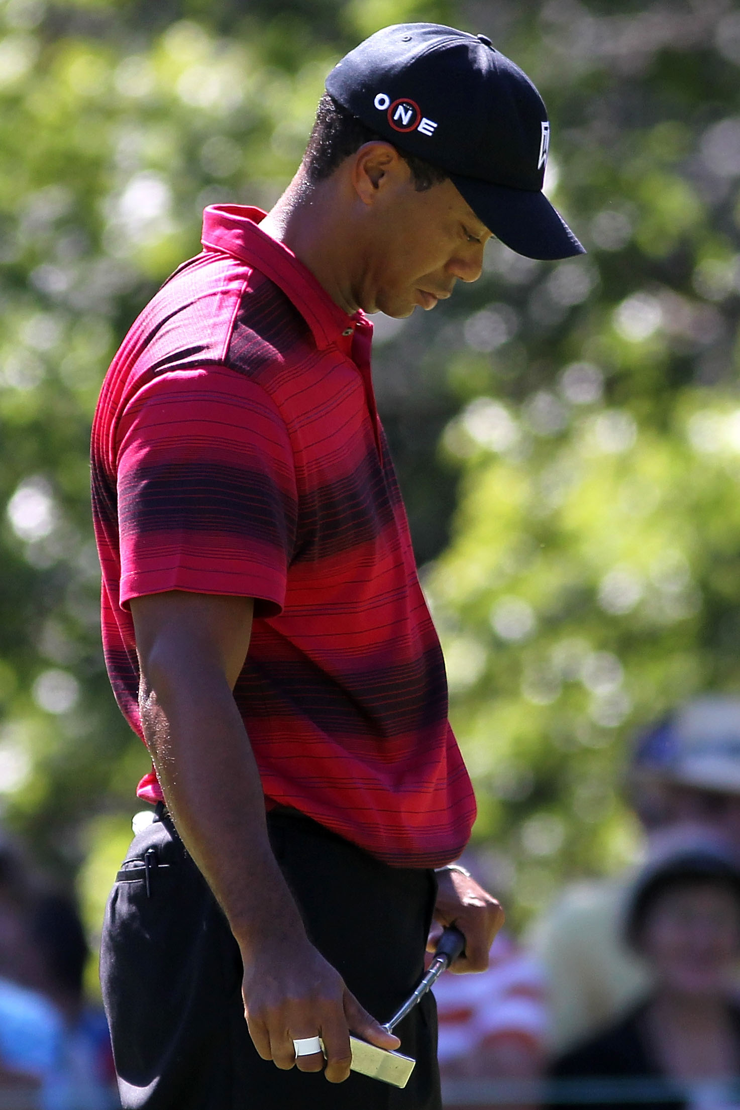 LEMONT, IL - SEPTEMBER 12:  Tiger Woods reacts after missing a putt on the fourth hole during the final round of the BMW Championship at Cog Hill Golf & Country Club on September 12, 2010 in Lemont, Illinois.  (Photo by Maxx Wolfson/Getty Images)