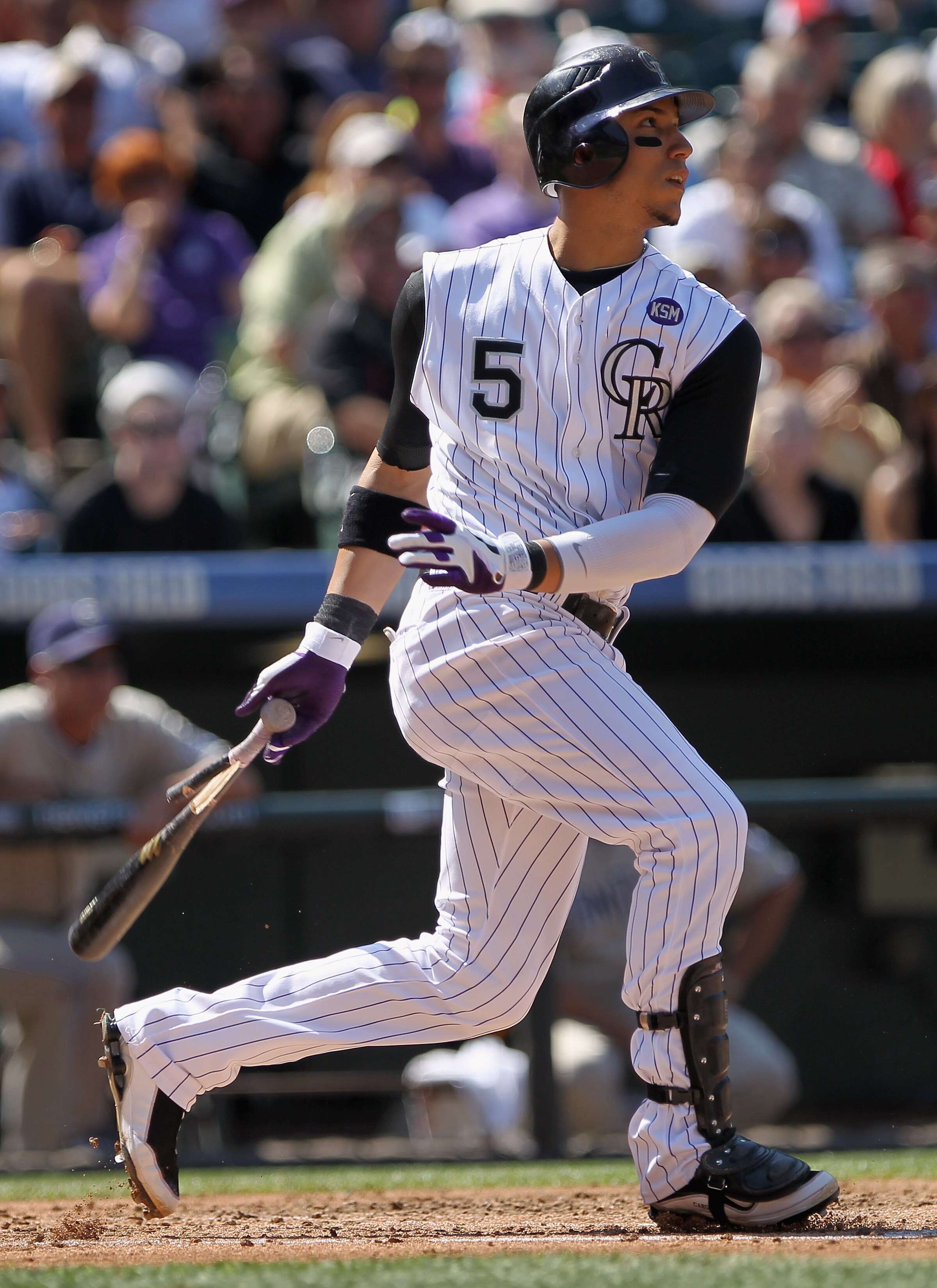 DENVER - SEPTEMBER 15:  Carlos Gonzalez #5 of the Colorado Rockies hits an RBI single to score Jorge De La Rosa to give the Rockies a 2-1 lead over the San Diego Padres in the third inning at Coors Field on September 15, 2010 in Denver, Colorado.  (Photo